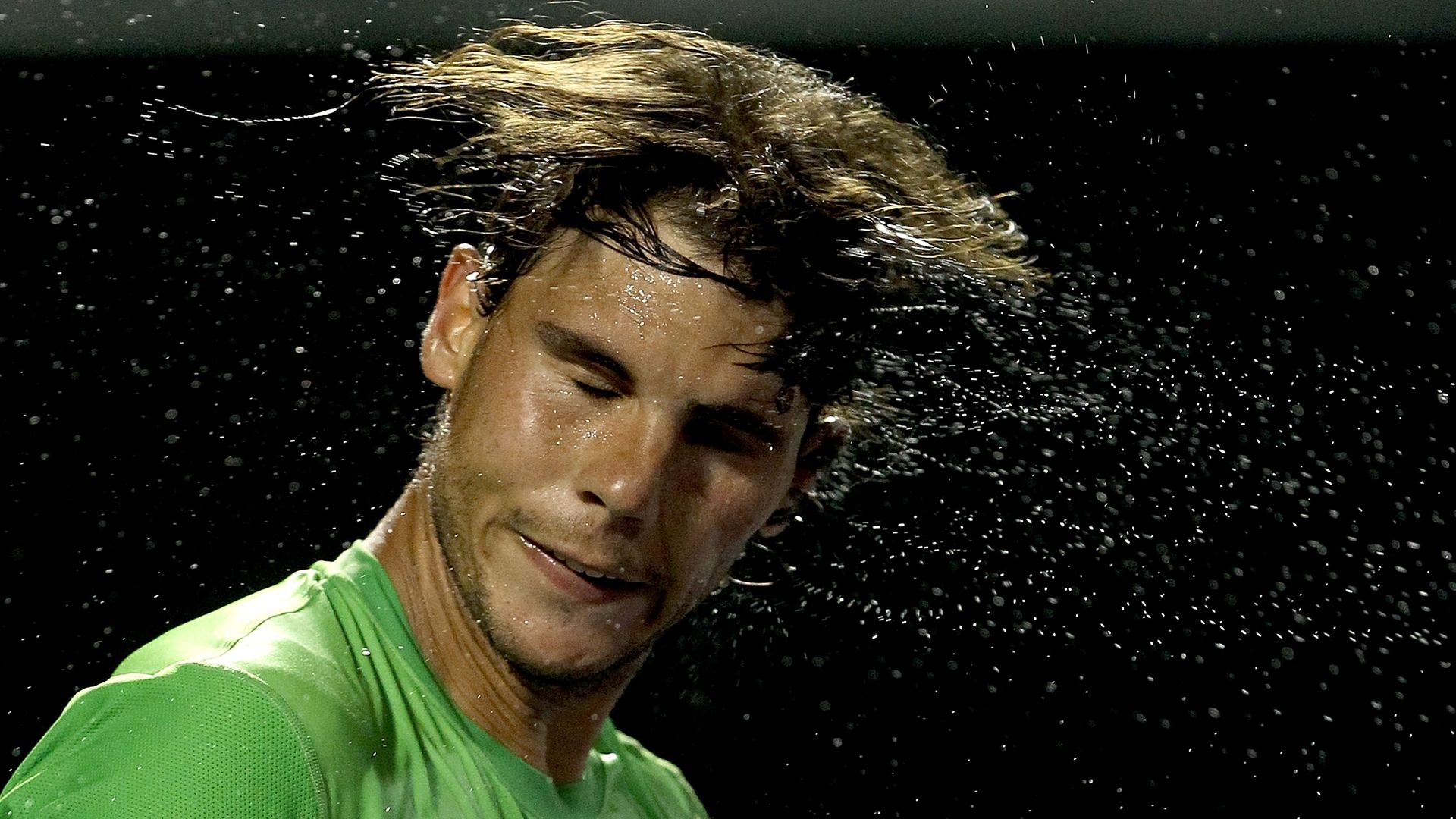 Rafael Nadal shakes the sweat from his hair after a win in the Sony Ericsson Open