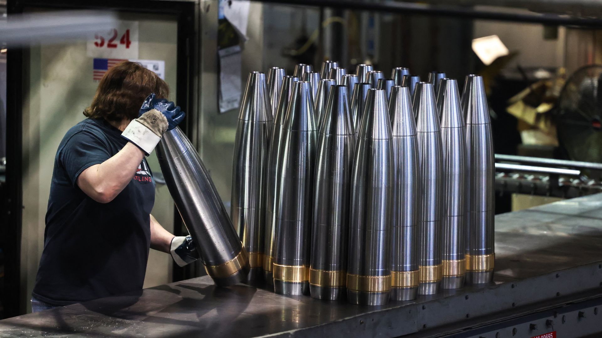 An employee handles 155 mm caliber shells after the manufacturing process at the Scranton Army Ammunition Plant (SCAAP) in Scranton, Pennsylvania on April 16, 2024. 
