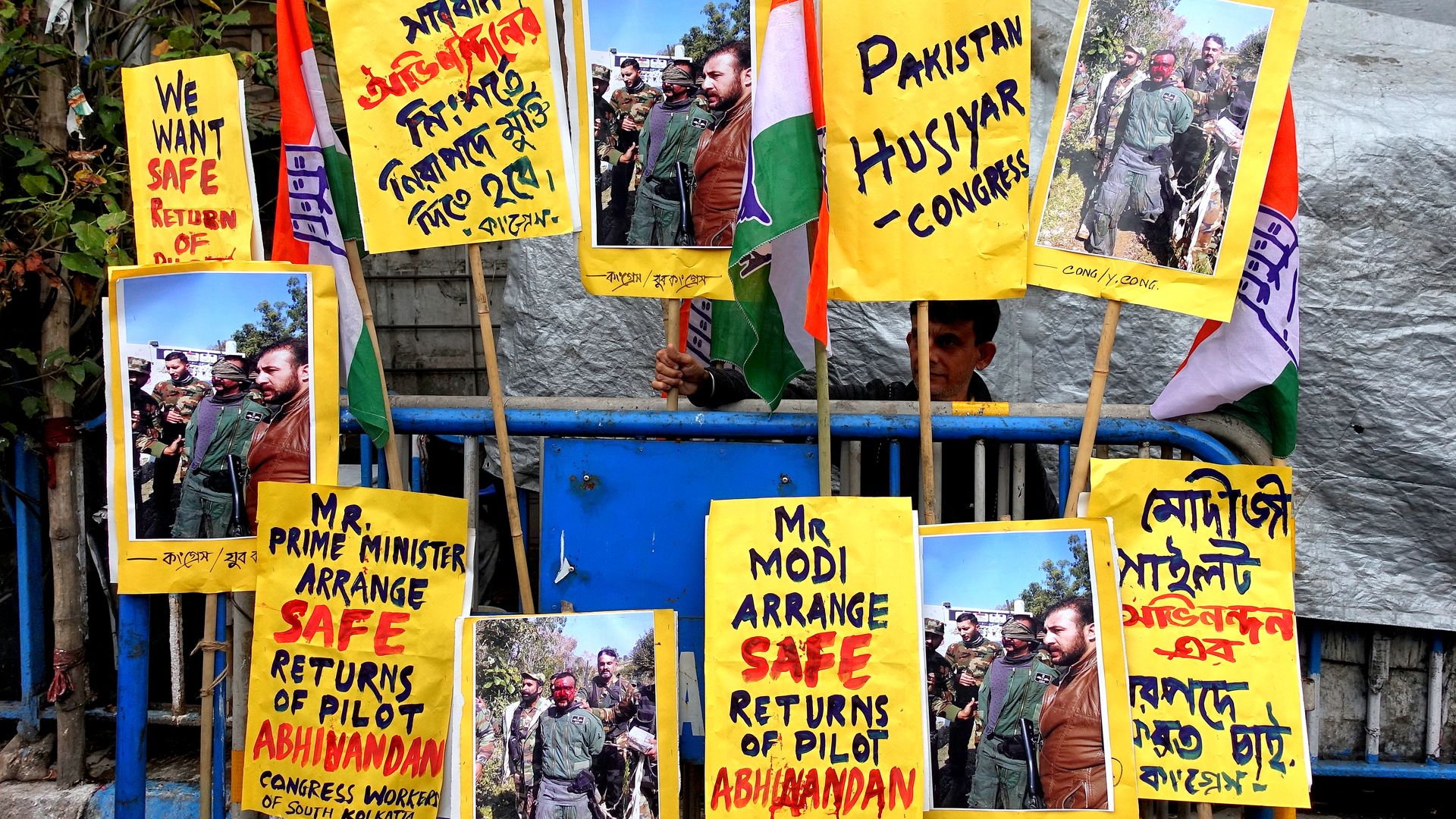 In this image, various yellow signs call for the pilot to be returned home.