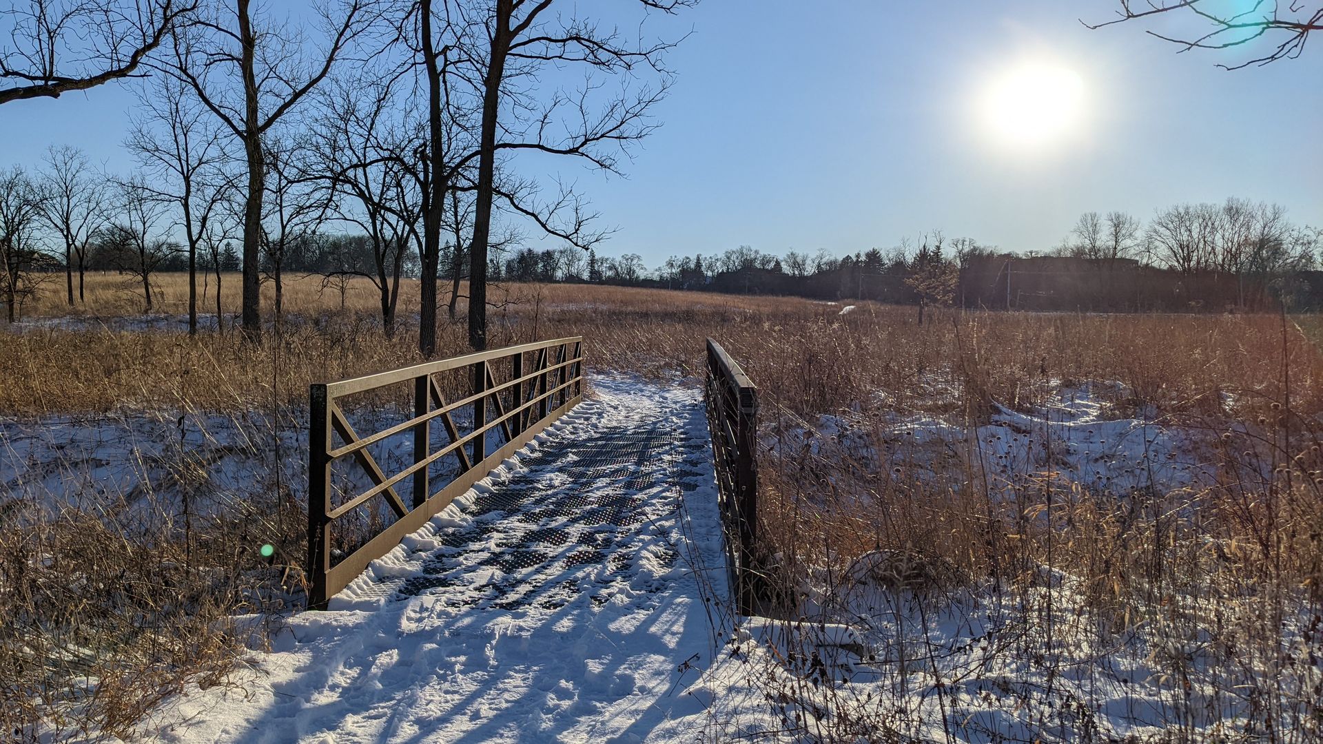 Photo of a snowy foot bridge. 