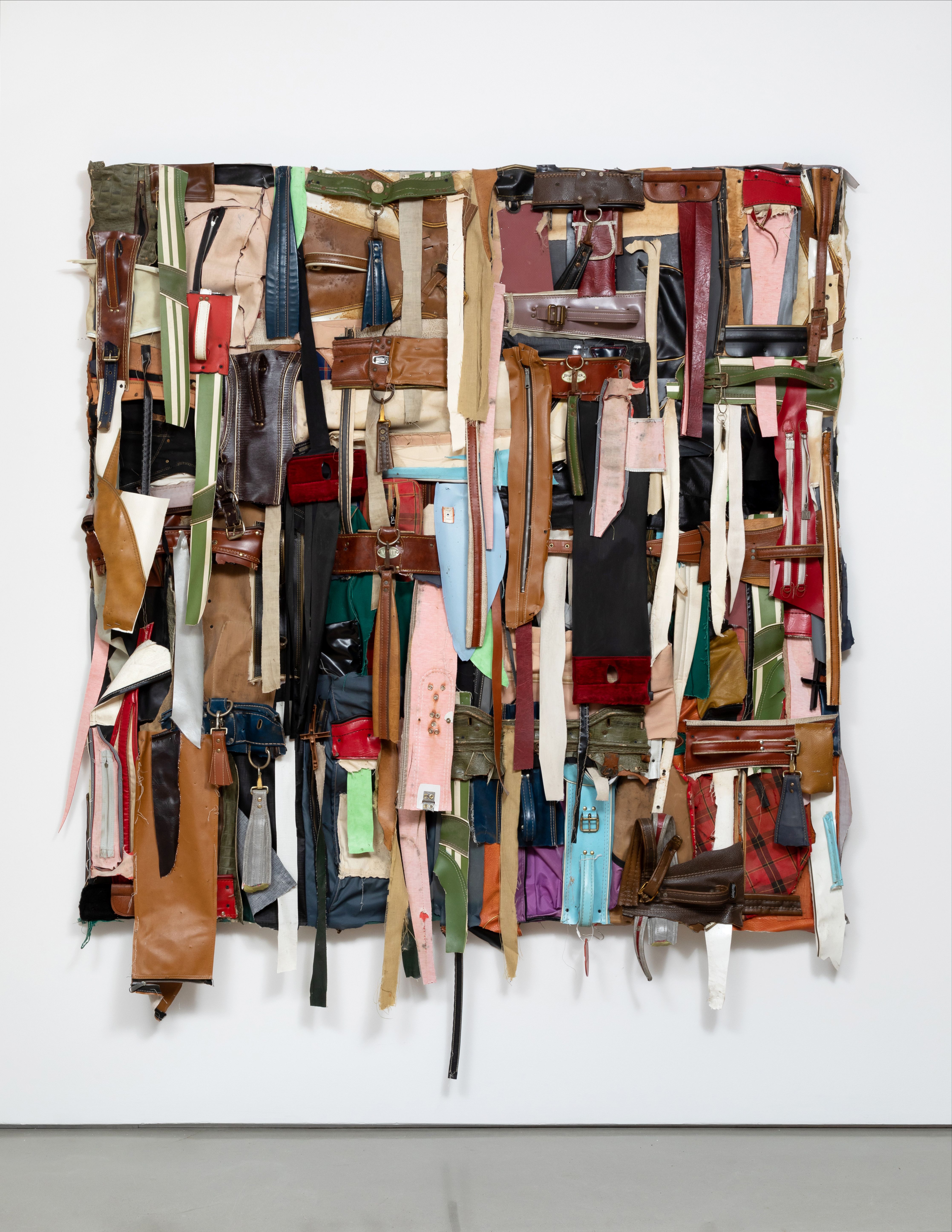 shredded ribbons of golf bags placed on a square pannel