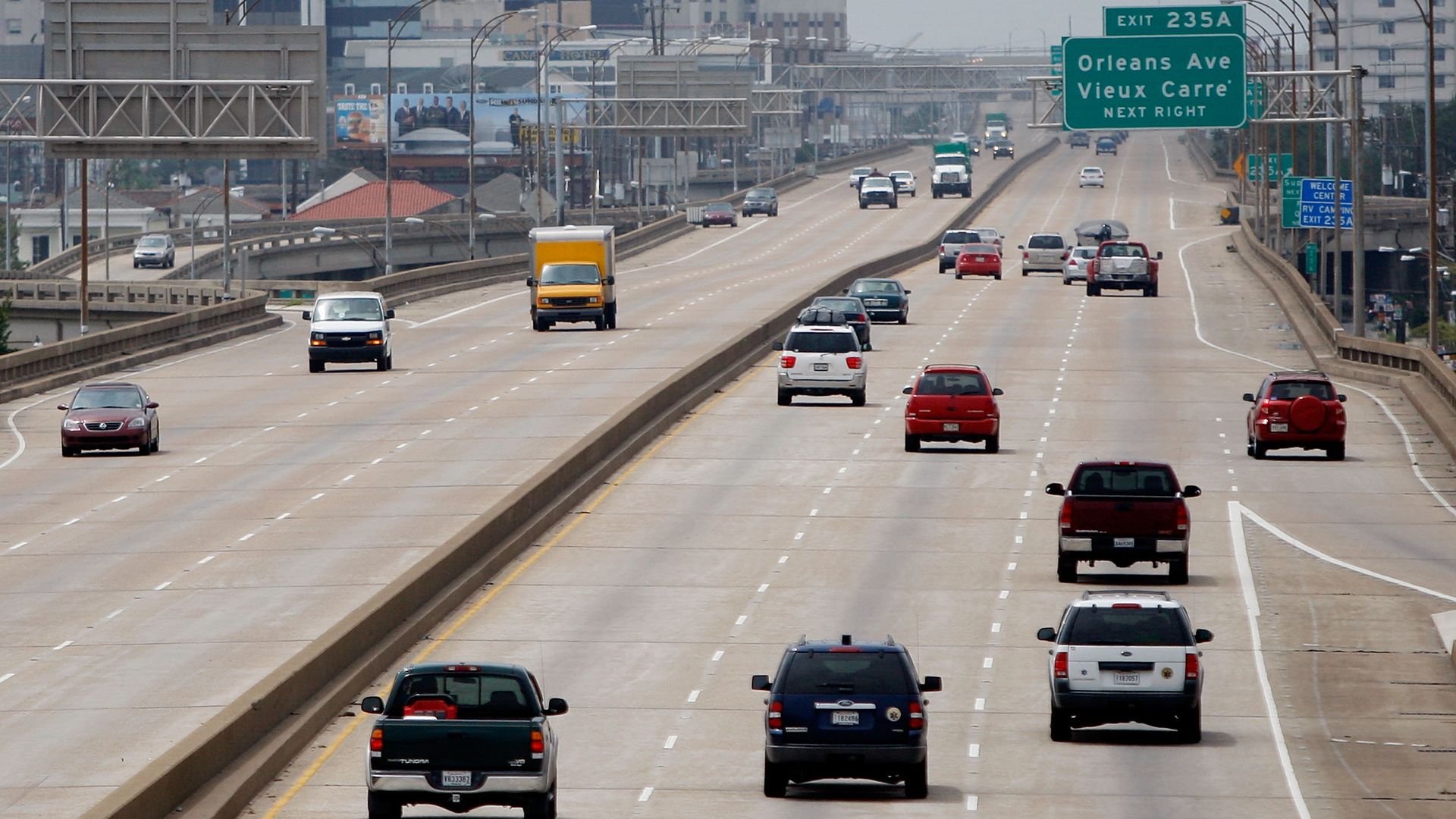 Image shows cars driving on the interstate with the New Orleans skyline in the background.