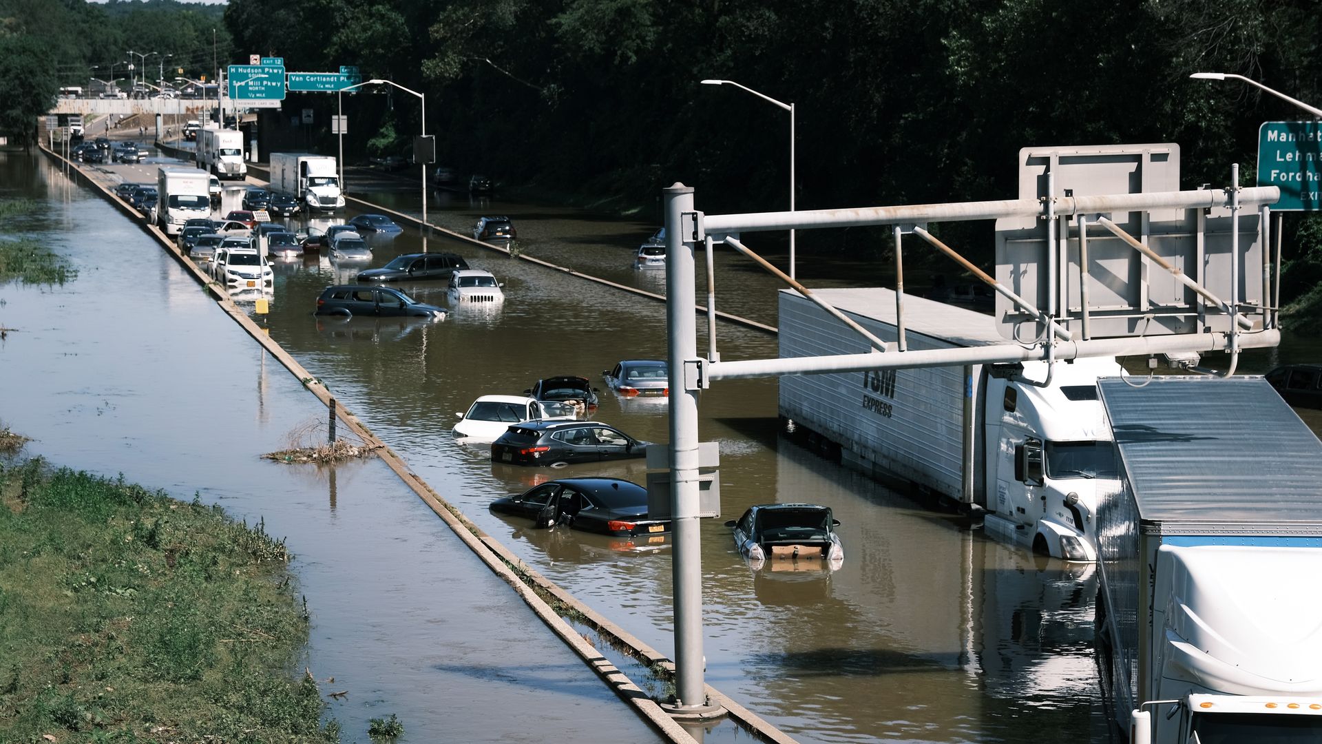 Flooded cars sit on a highway full of water after a deluge.
