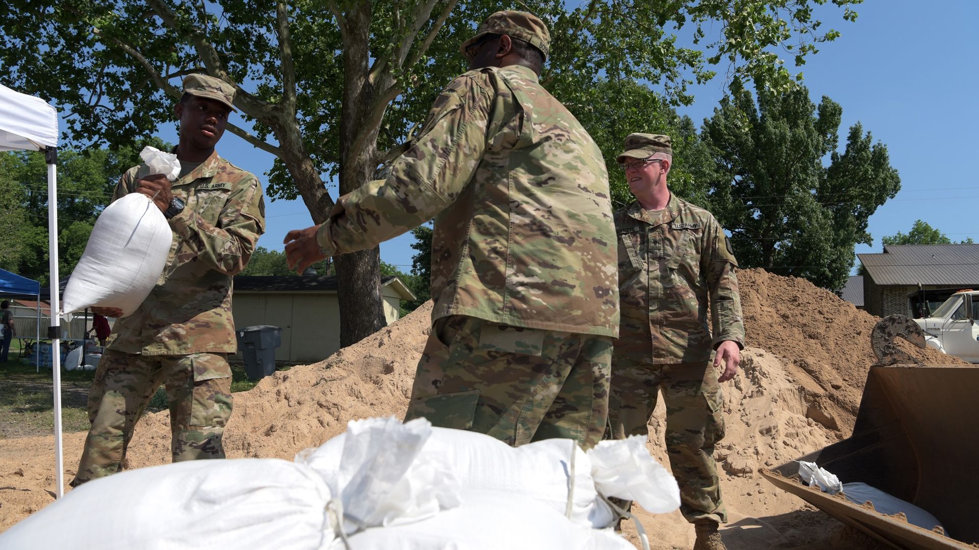 Arkansas National Guard Soldiers assist the U.S. Army Corps of Engineers and the city of Dardanelle, Arkansas, fill and load sandbags in preparation for flood waters near the city.