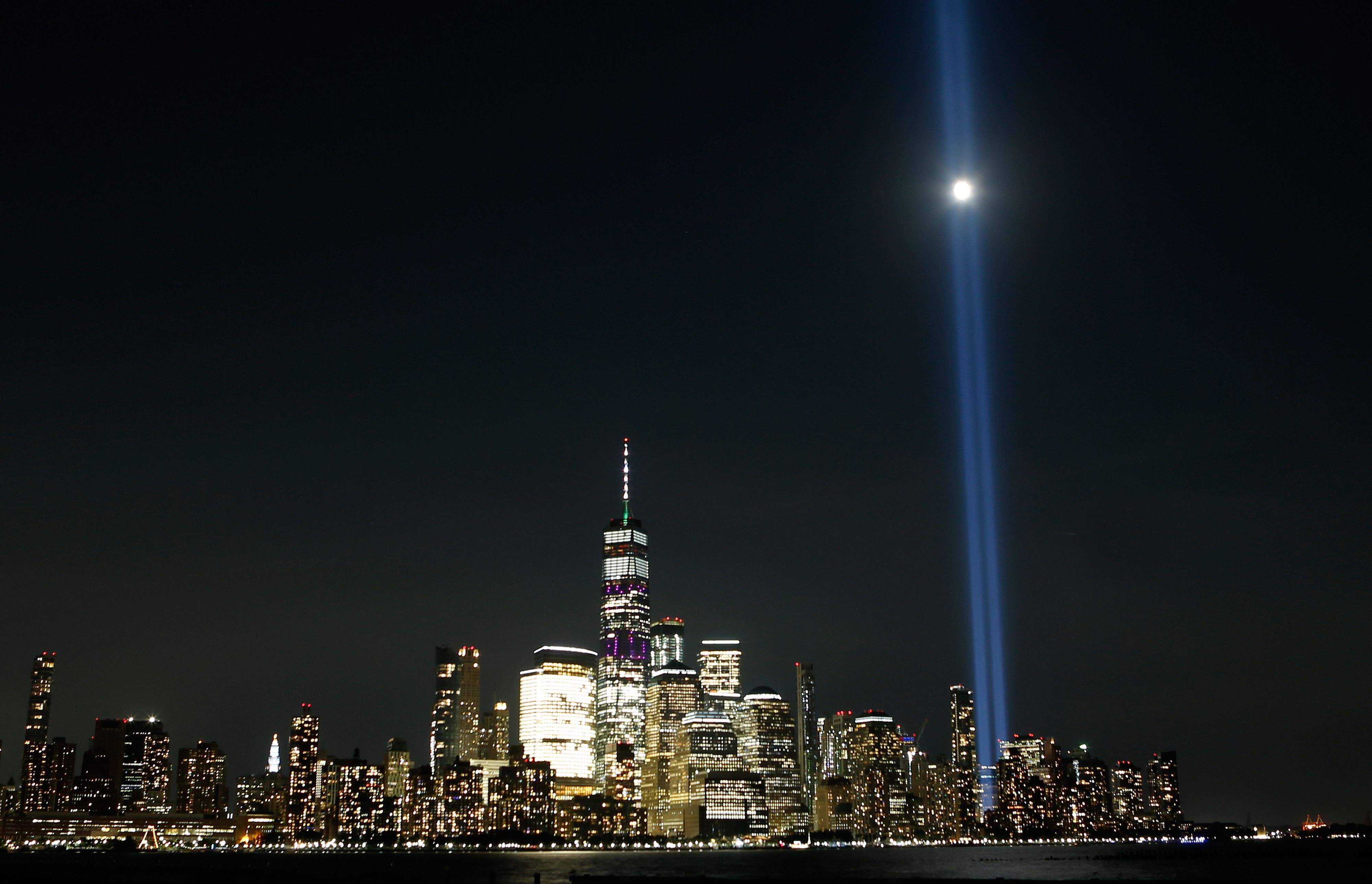 The moon passes through the annual Tribute in Light on the skyline of lower Manhattan on the eve of the 18th anniversary of the 9/11 attacks. Photo: Gary Hershorn/Getty Images