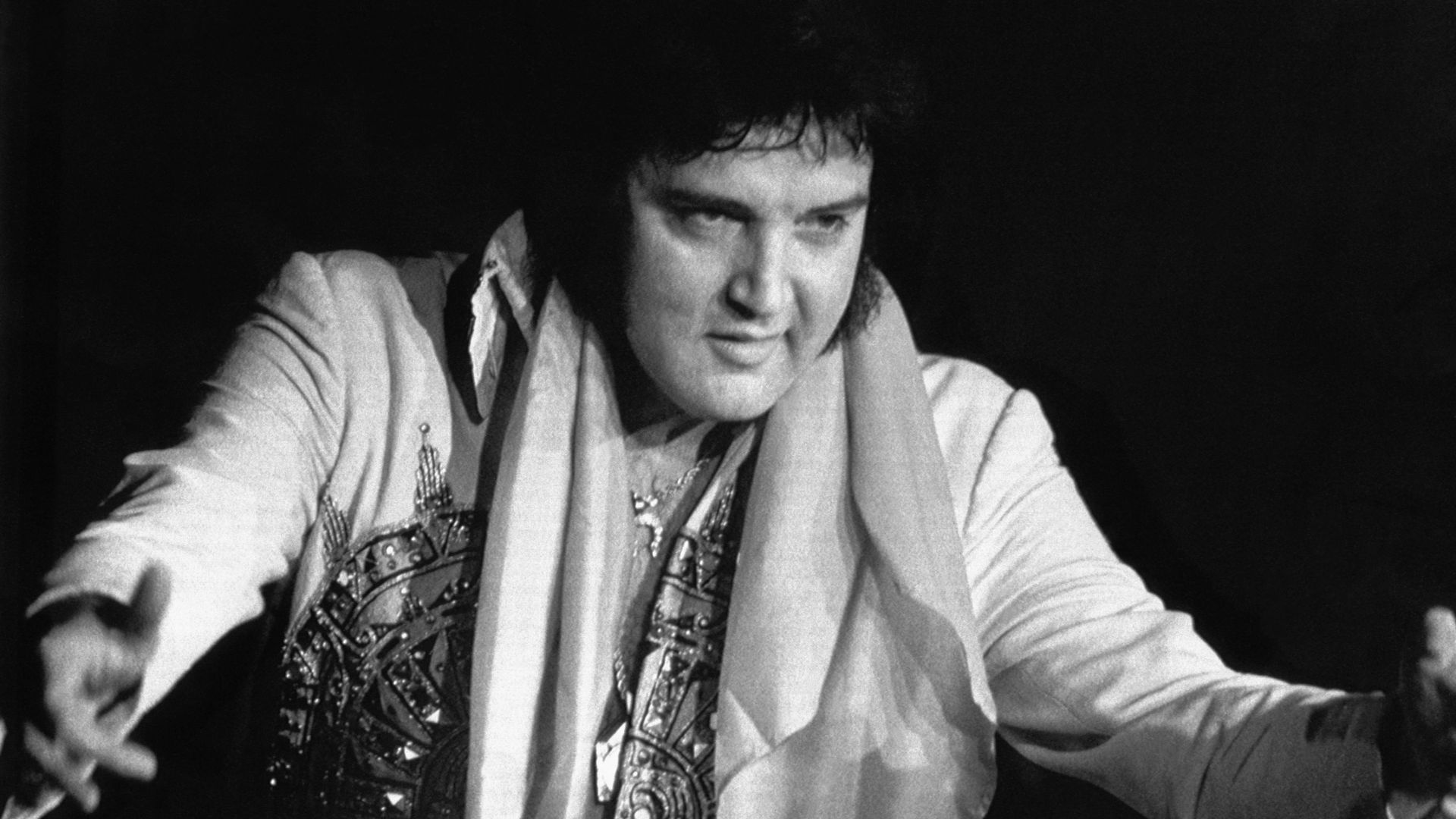 Elvis Presley, 42, died 8/16 in Memphis, TN, of repiratory failure at Baptist Hospital. Presley, the gyrating, hip-swinging King of Rock and Roll is shown during 6/20 concert here.