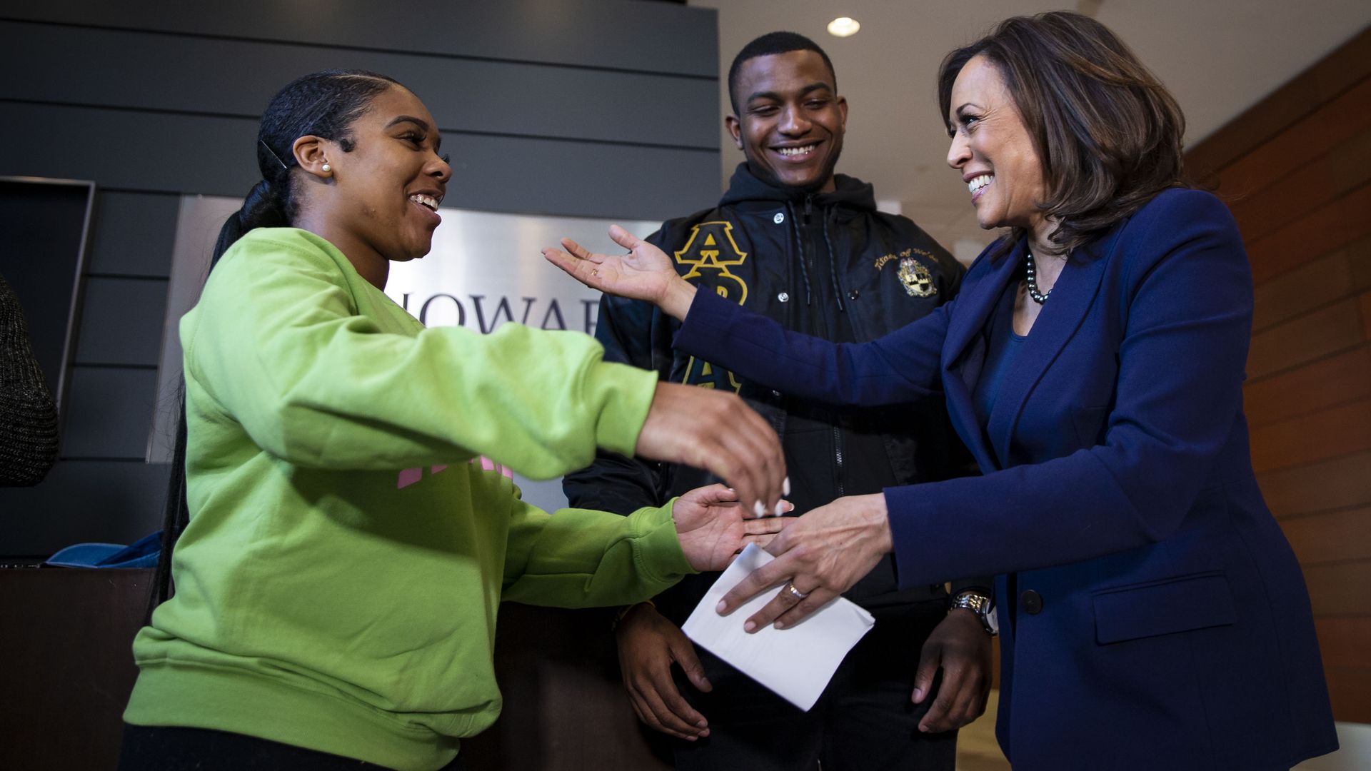 U.S. Sen. Kamala Harris hugs Mara Peoples, Executive Vice President of the Howard University Student Association, beside Amos Jackson III, Executive President