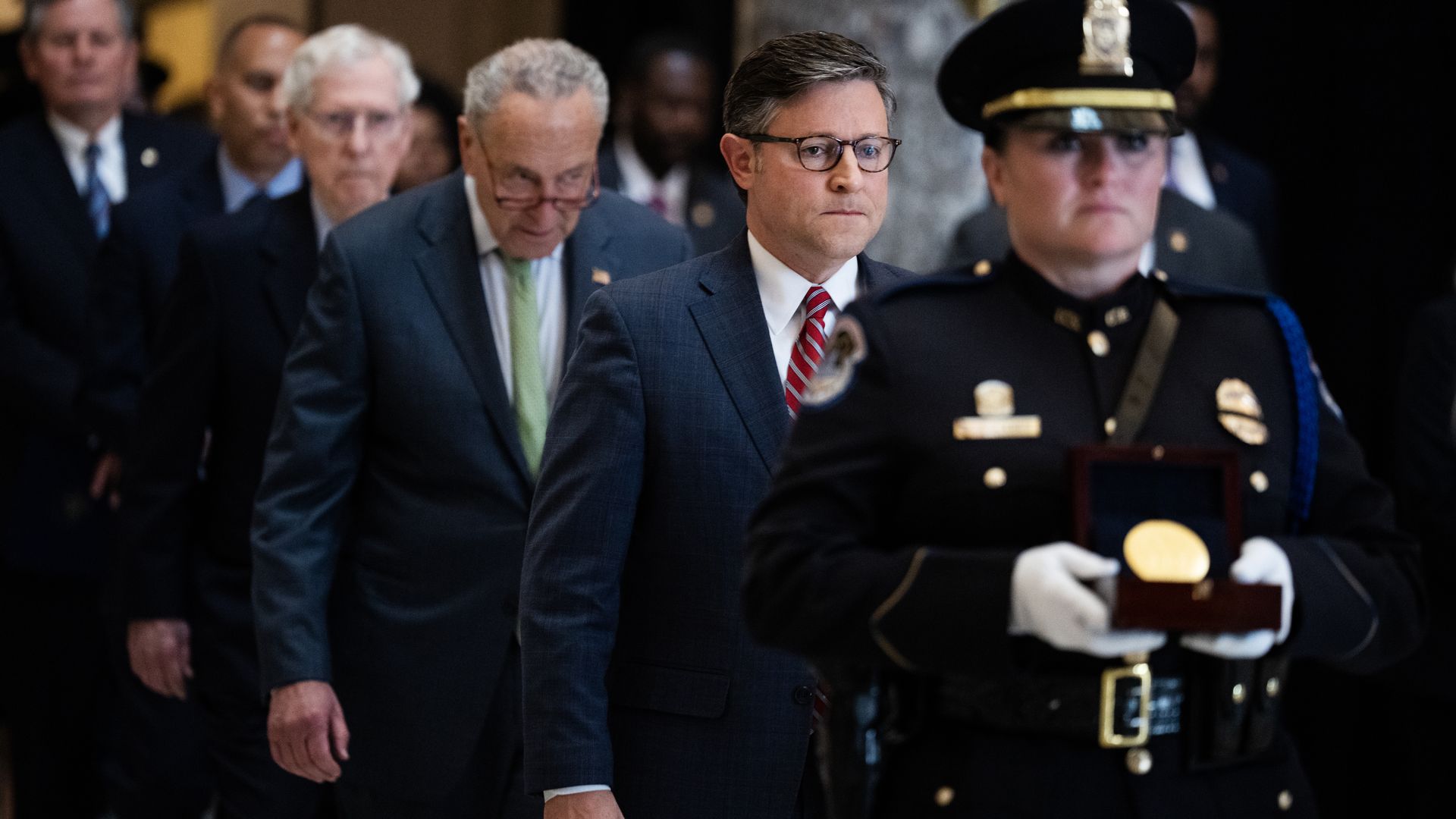 A Capitol Police officer carries a Congressional Gold Medal followed by Speaker of the House Mike Johnson, R-La., Senate Majority Leader Charles Schumer, D-N.Y., Senate Minority Leader Mitch McConnell, R-Ky., House Minority Leader Hakeem Jeffries, D-N.Y., and Sen. Steve Daines, R-Mont.