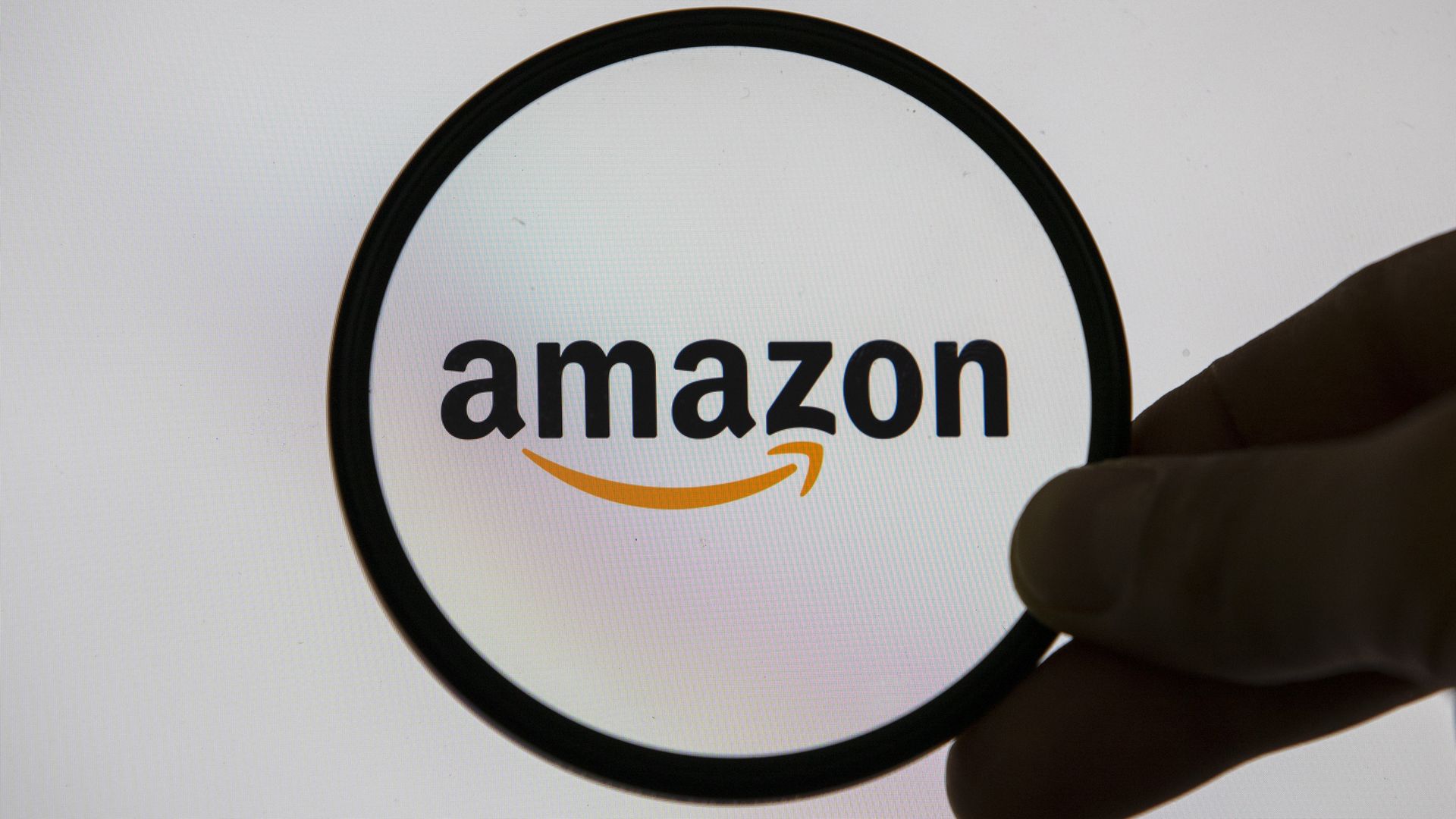 Amazon logo in a magnifying glass. 