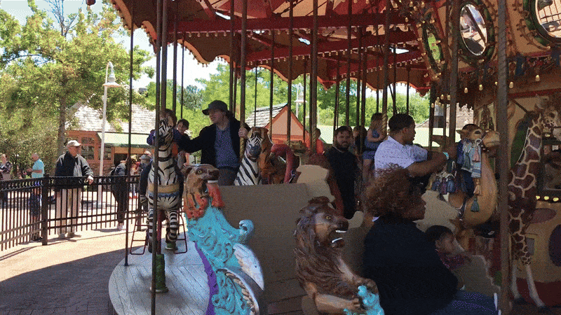 Image shows people on a carousel.