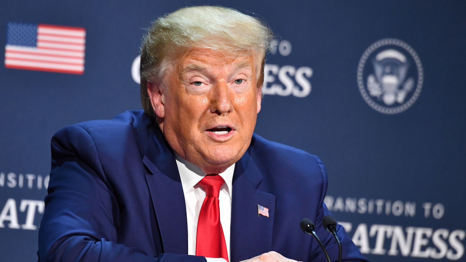 President Trump speaking at a table