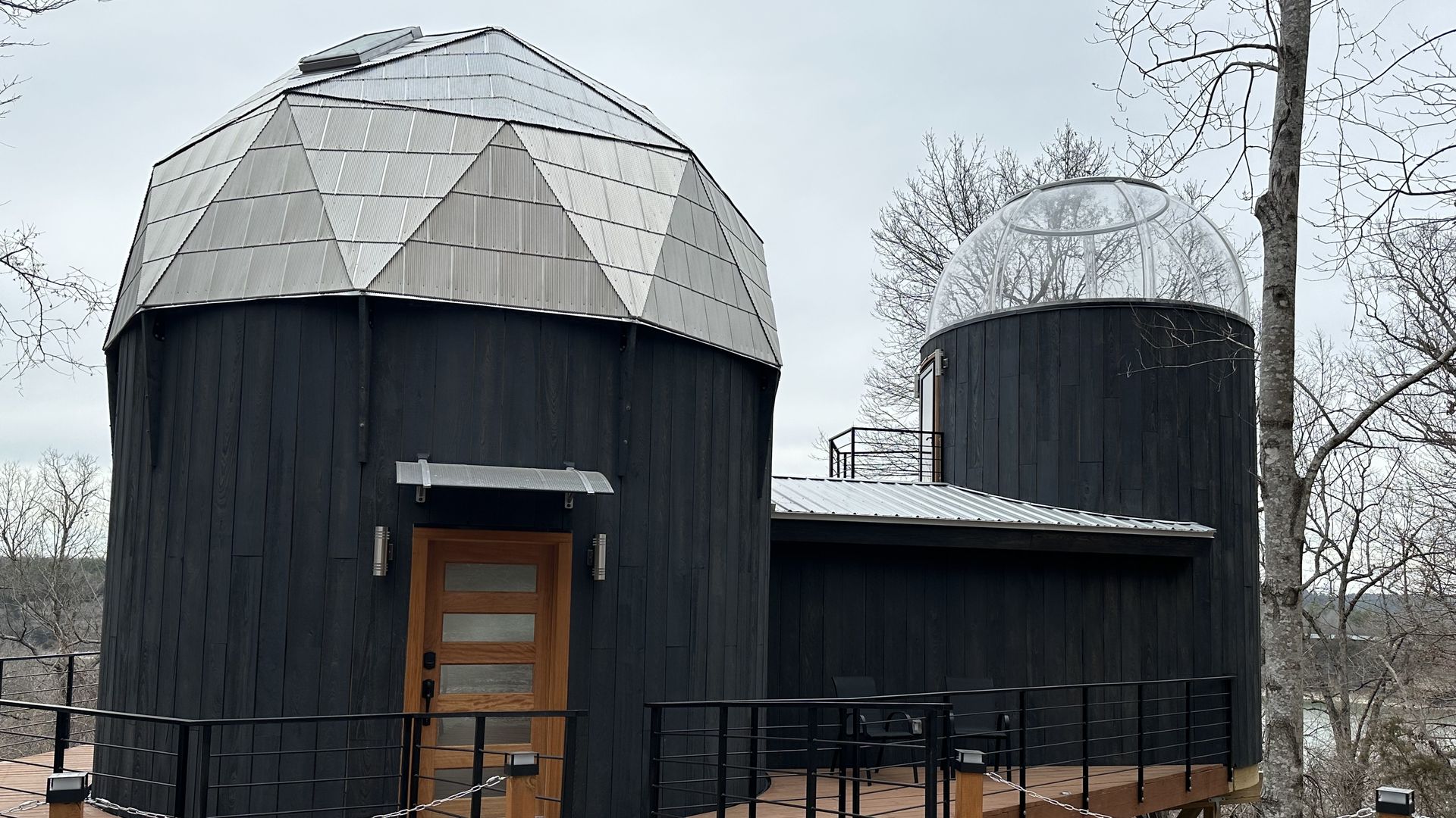 A treehouse Airbnb with two domes on either end.