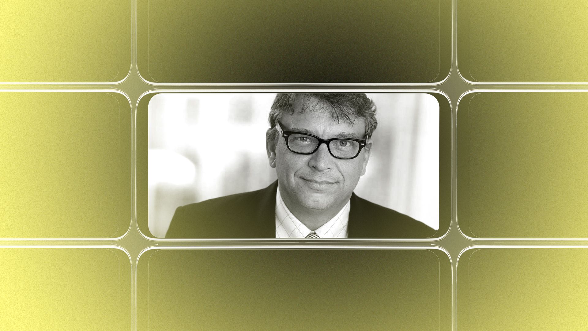 A photo of a man wearing glasses and a suit, framed by a smartphone