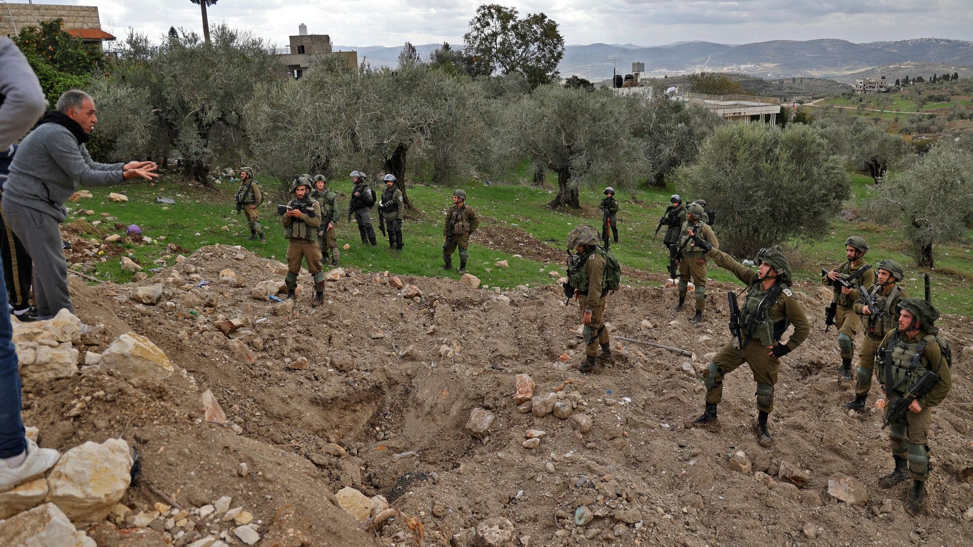 Palestinian residents of the West Bank village of Burqah confront Israeli soldiers on December 17, 2021, after reported attacks by Israeli settlers on the village.