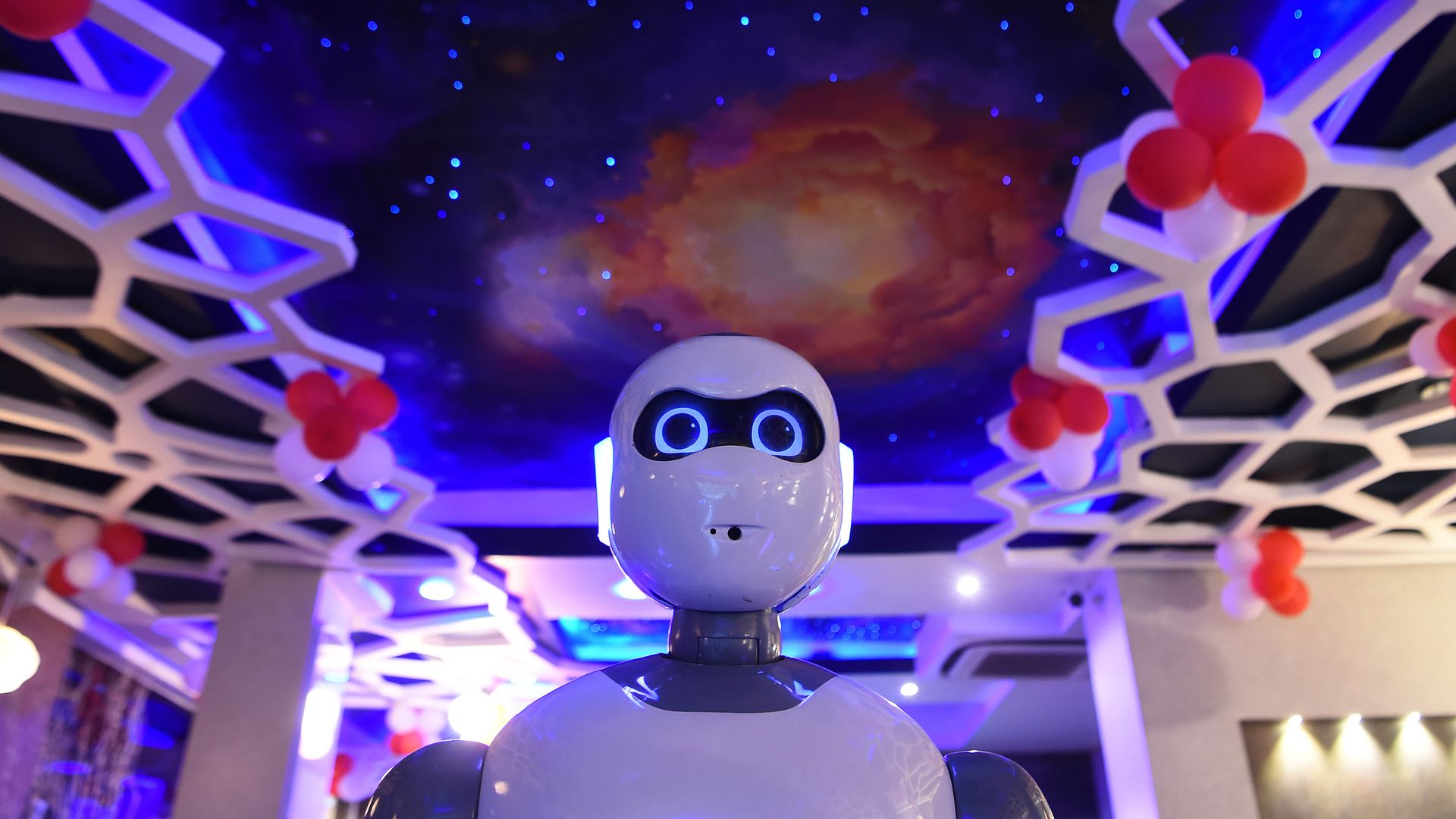 A robot glides through a restaurant.