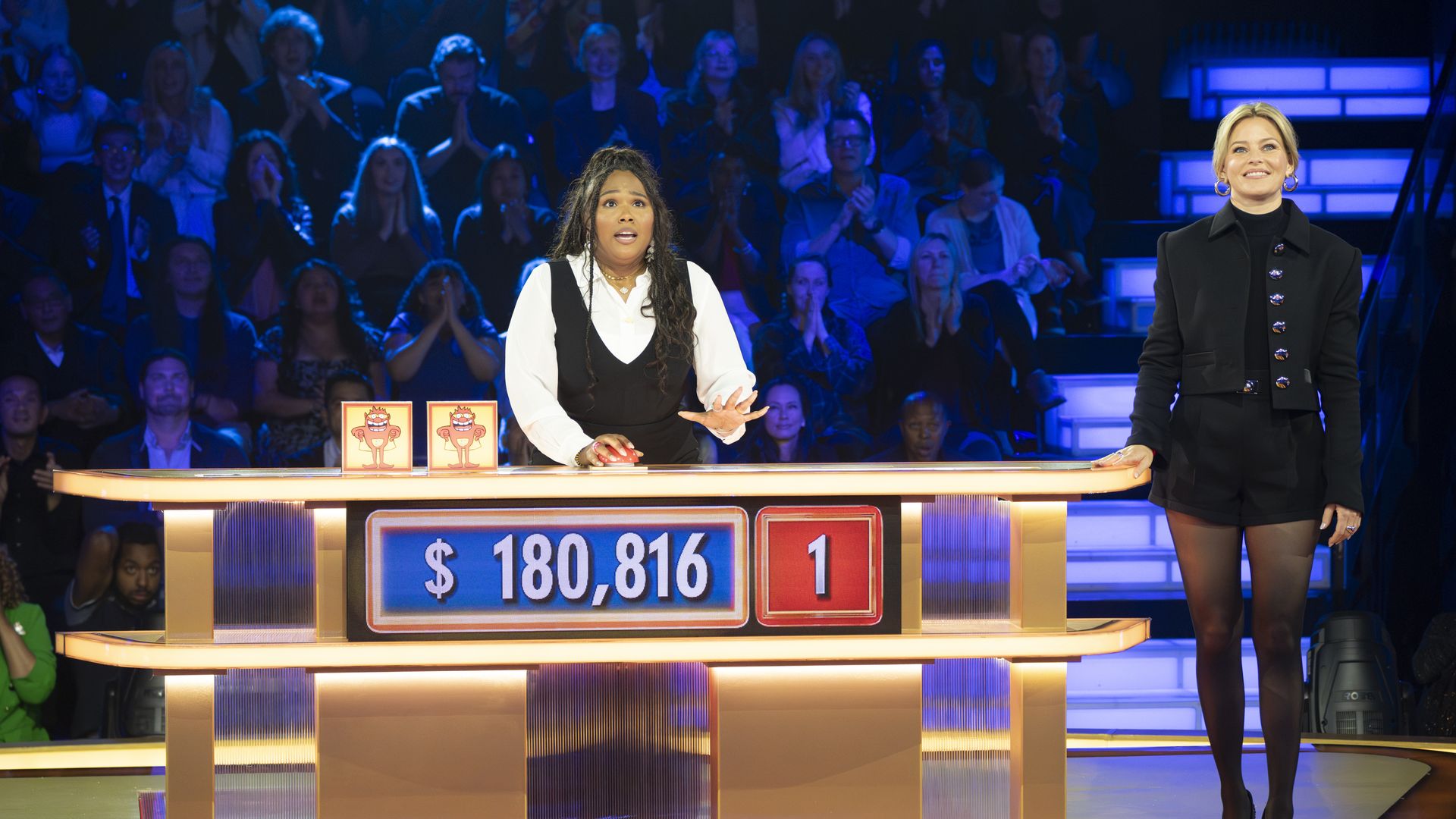 Photo of a contestant with $180,816 flashing below her. 