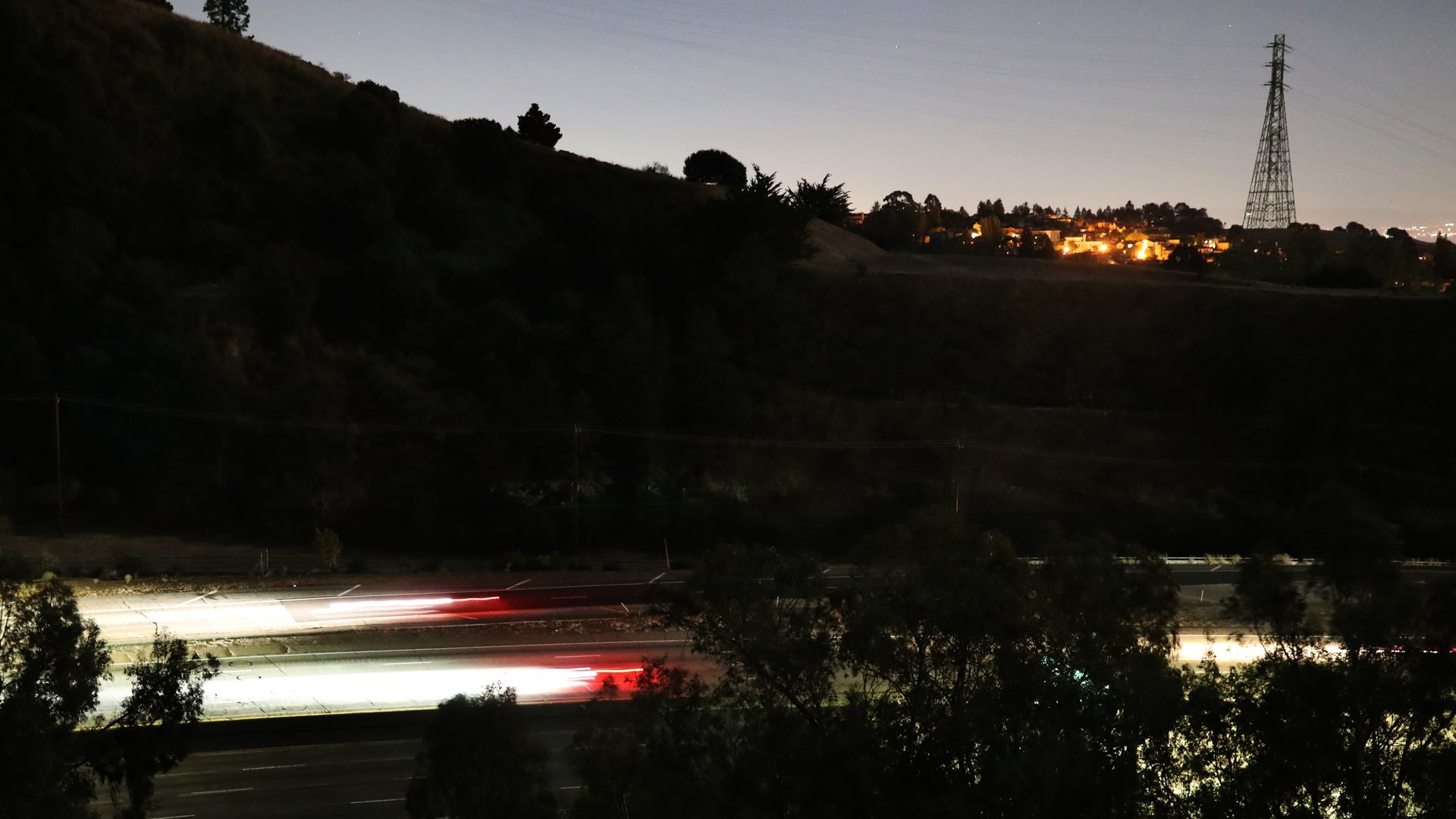 Streaks of lights from vehicles drive along highway 24 during the PG&E power outage in Oakland, Calif., on Thursday, Oct. 10
