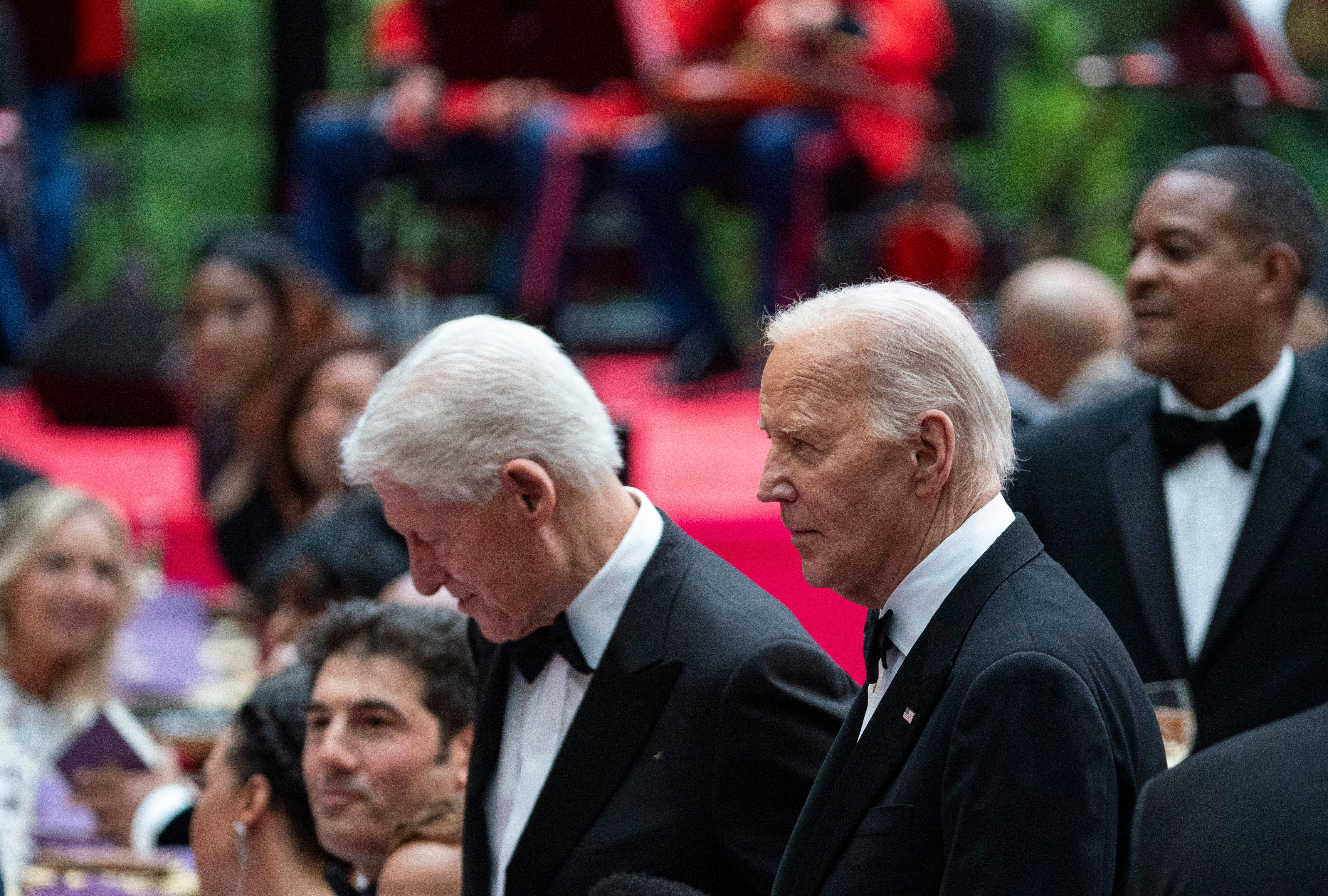 President Biden and former President Clinton wearing tuxedos at a formal event
