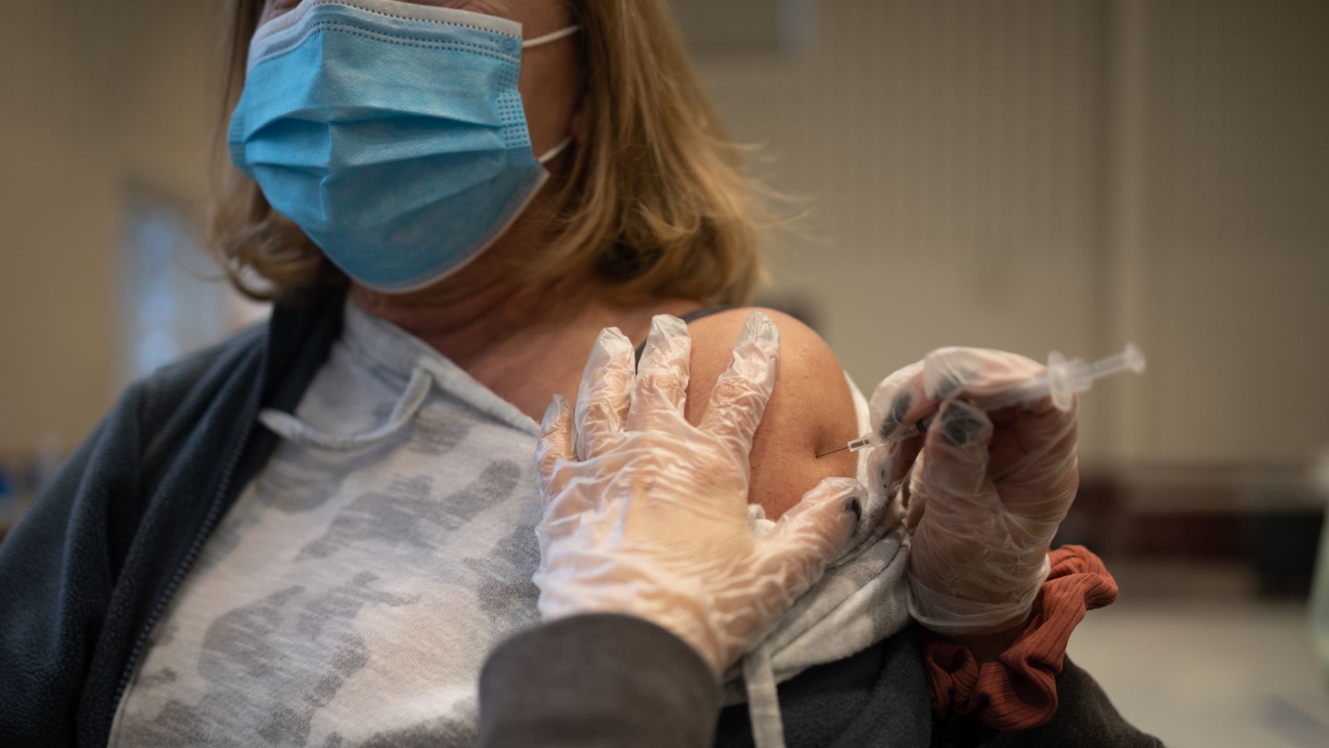 A resident receives a Covid-19 booster shot at a vaccine clinic inside Trinity Evangelic Lutheran Church in Lansdale, Pennsylvania, U.S, on Tuesday, Apr. 5, 2022. 