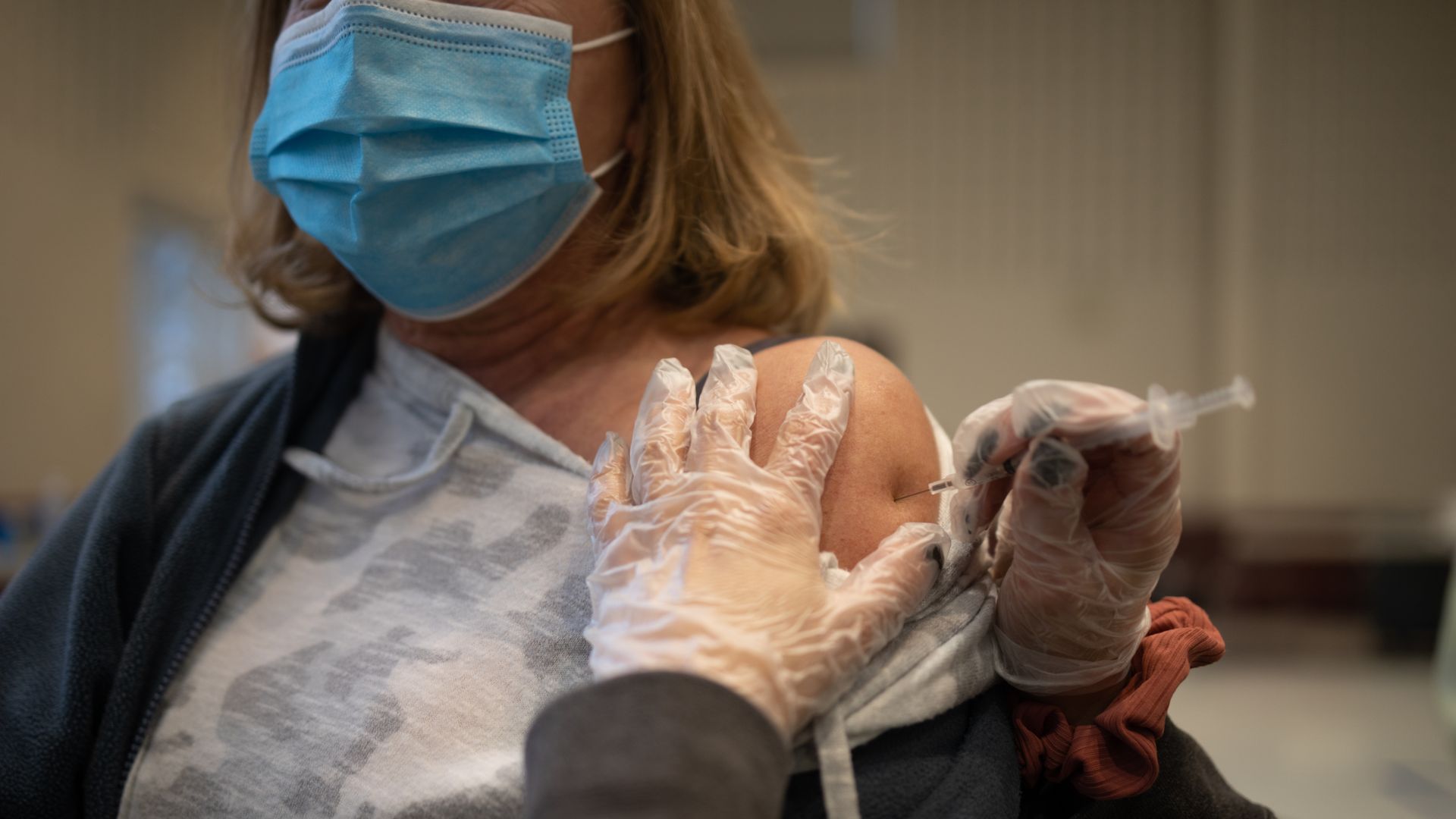 A resident receives a Covid-19 booster shot at a vaccine clinic inside Trinity Evangelic Lutheran Church in Lansdale, Pennsylvania, U.S, on Tuesday, Apr. 5, 2022.