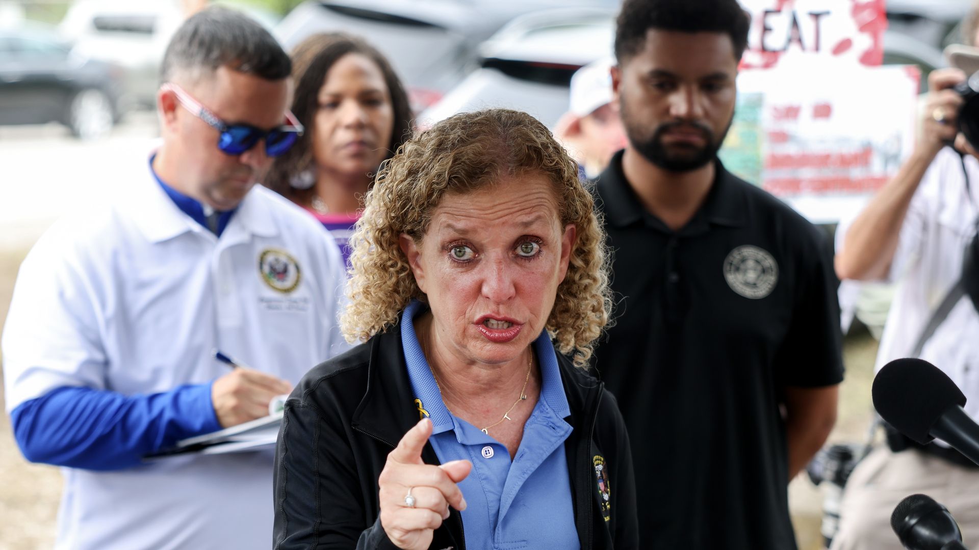 Rep. Debbie Wasserman Schultz (D-FL), Rep. Darren Soto (D-FL) (L), and Rep. Maxwell Frost (D-FL) during a press conference after visiting "Alligator Alcatraz" at the Dade-Collier Training and Transition Airport on July 12, 2025, in Ochopee, Florida.