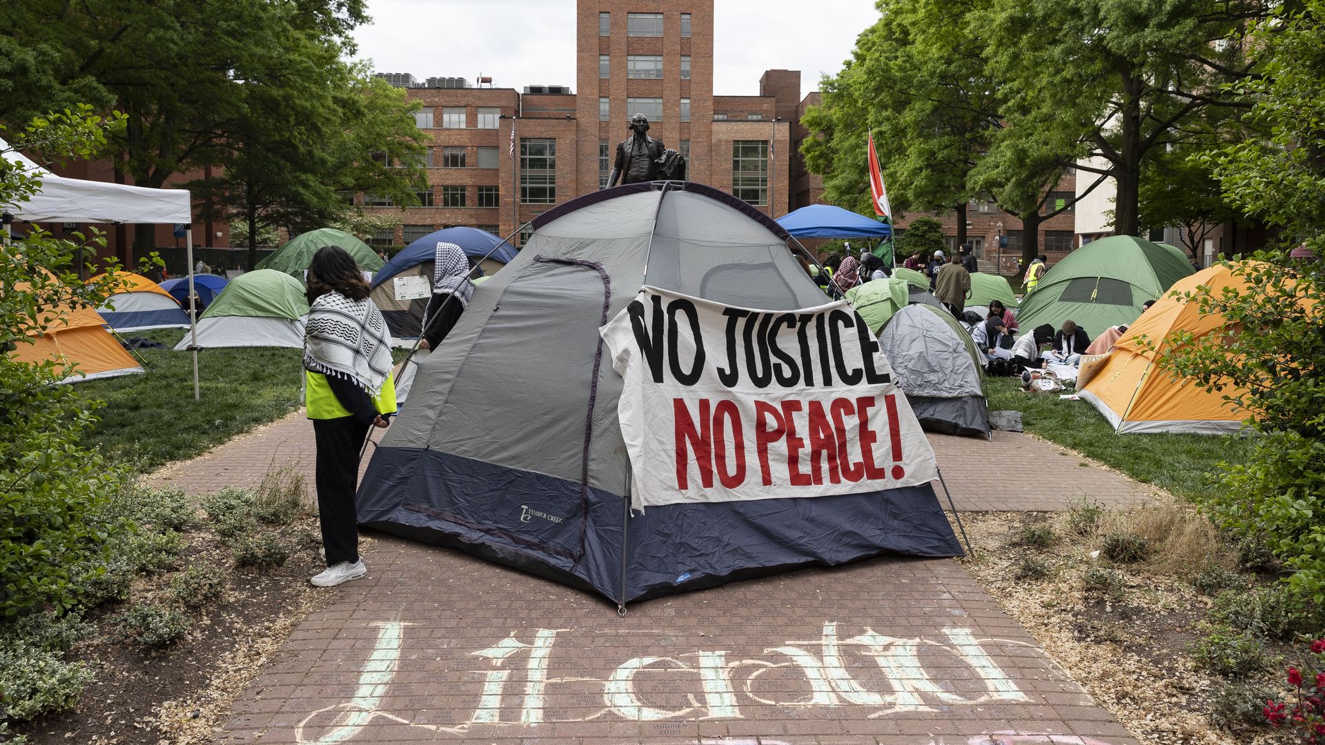 A tent with a sign reading "No justice, no peace."