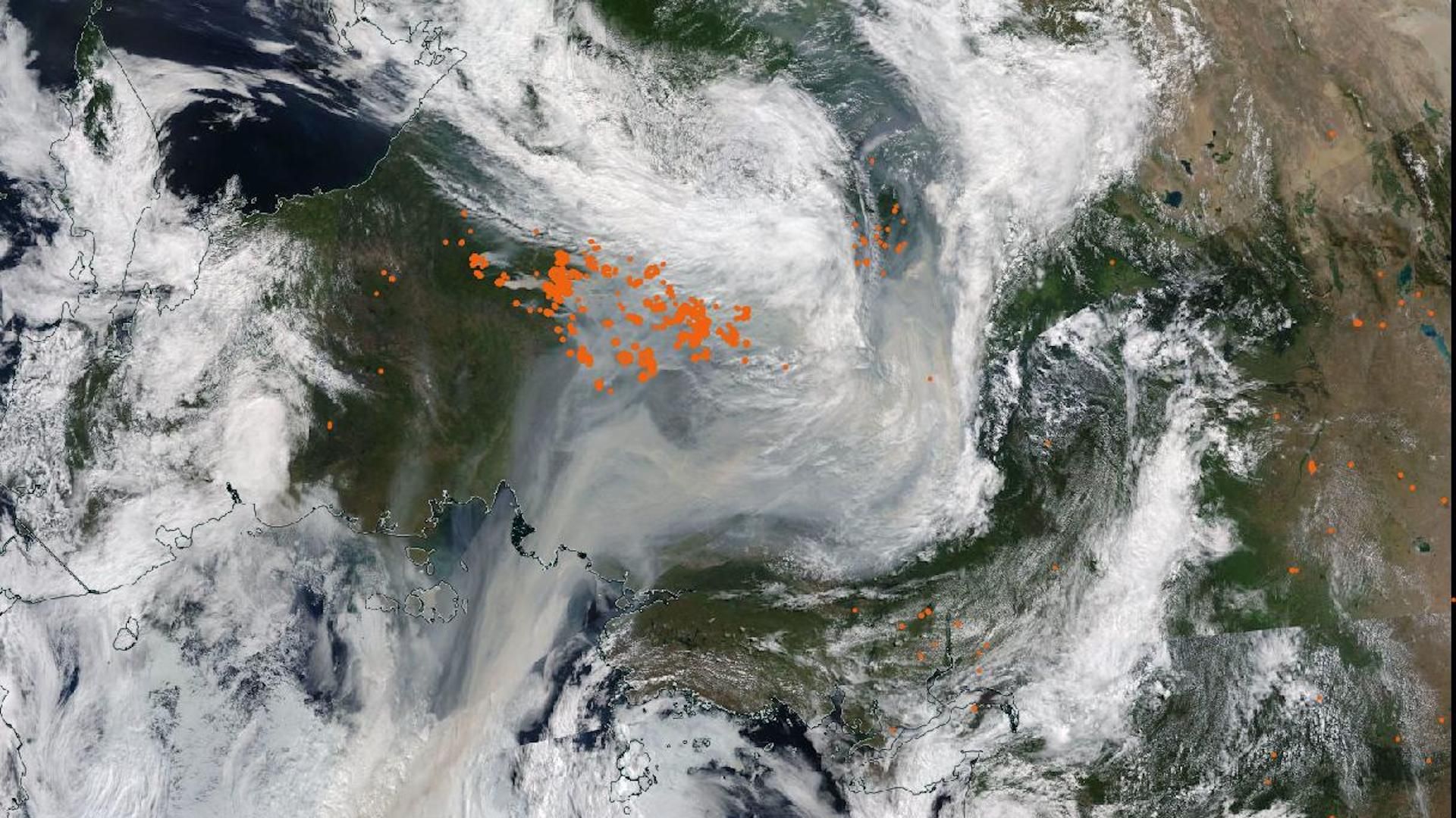 Satellite image showing clouds and wildfire smoke viewed from the top of the planet downwards.