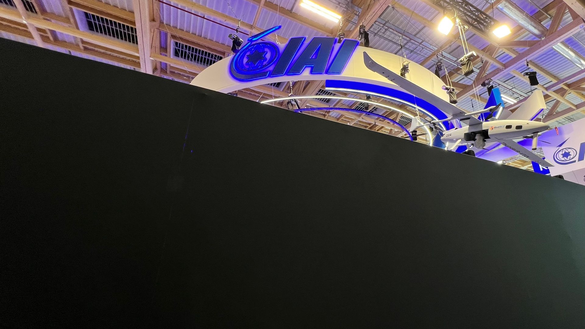 A large black wall blocks the view into defense contractor IAI's booth at an air show.