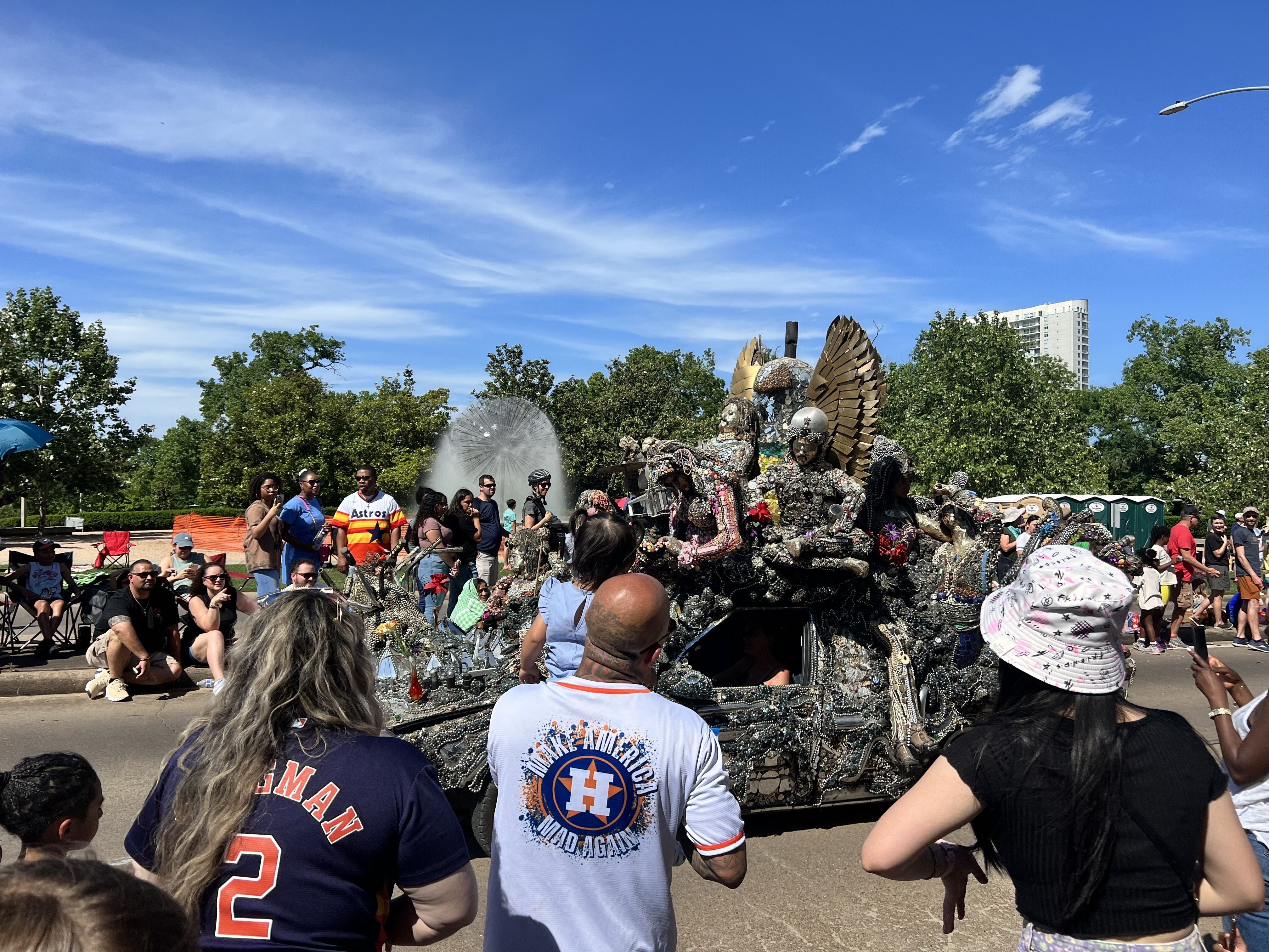Photo of a car decked in mosaic sculptures 