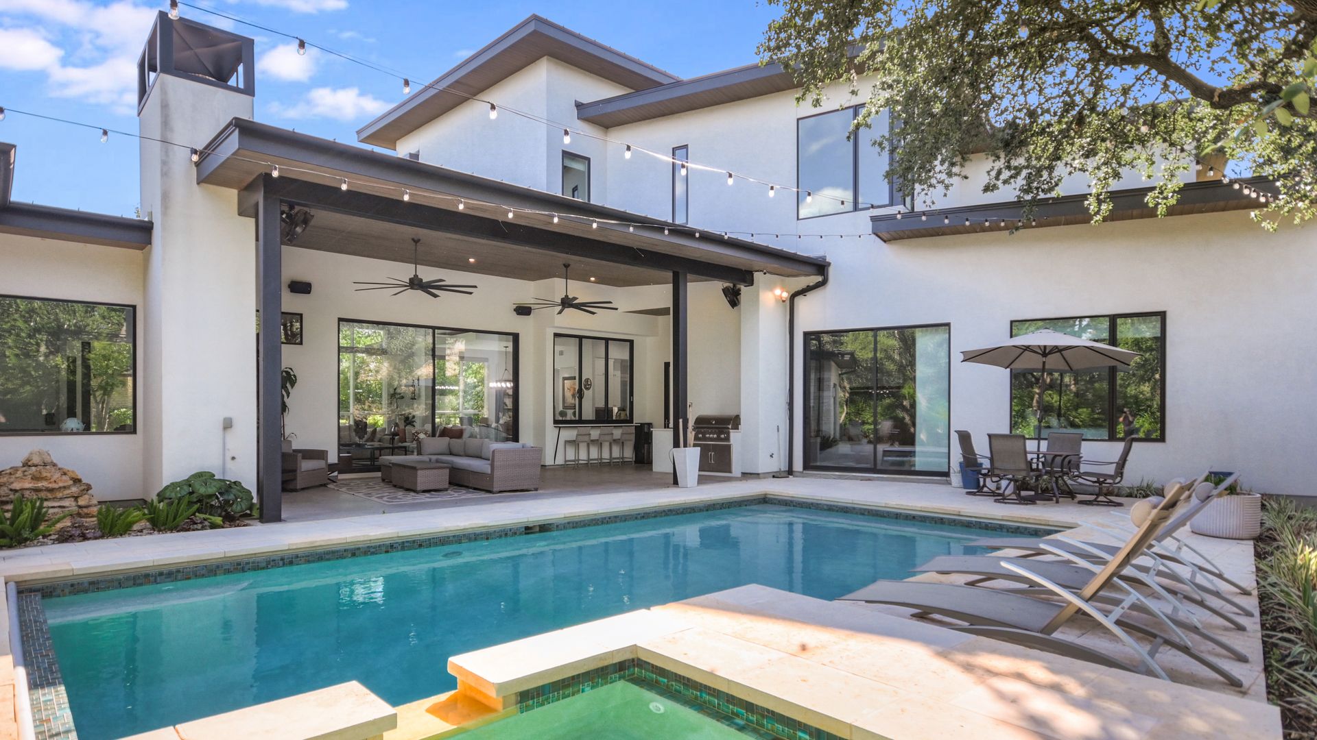 A view of a swimming pool behind a house.