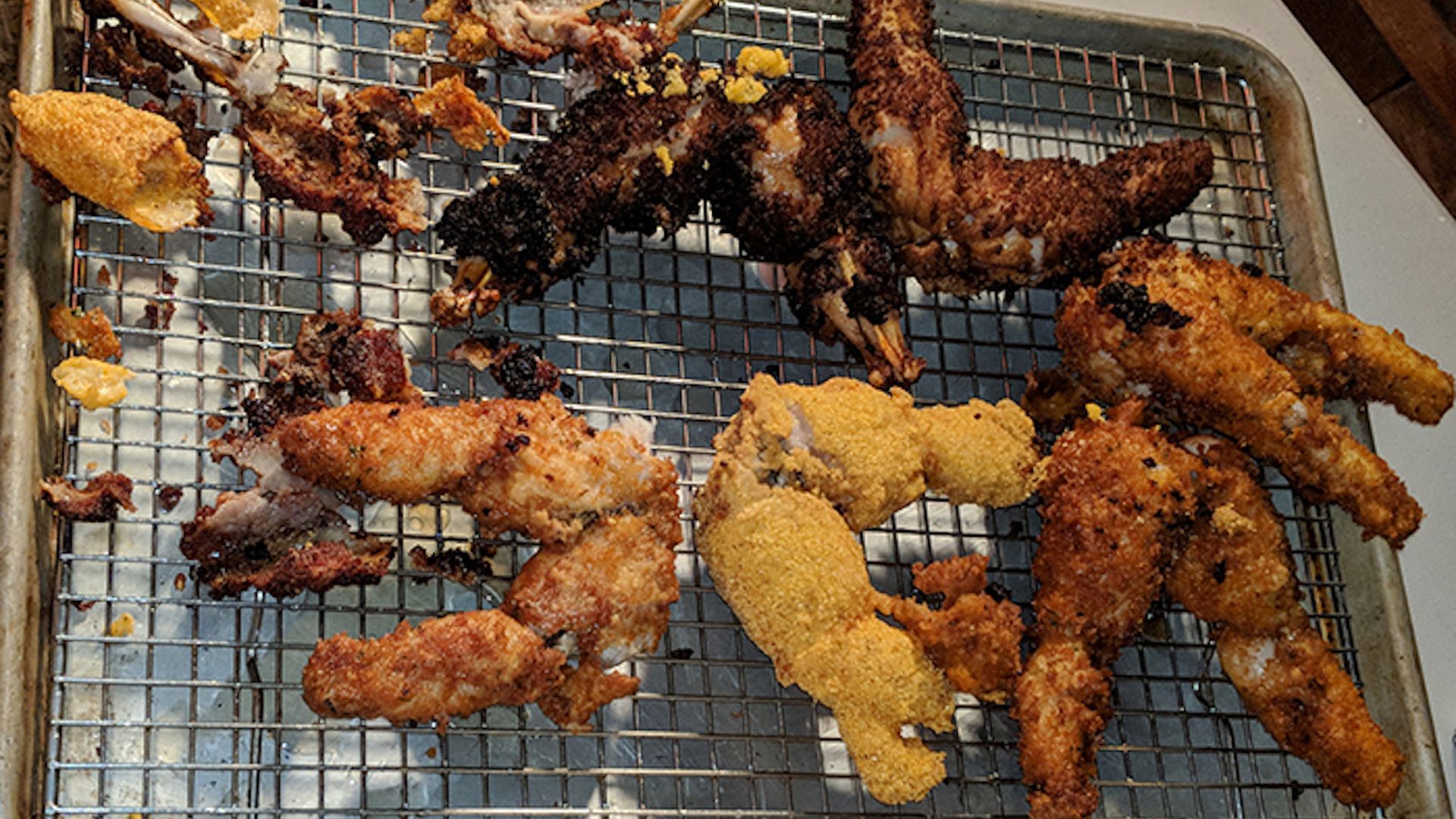 Fried frog legs on a grate.
