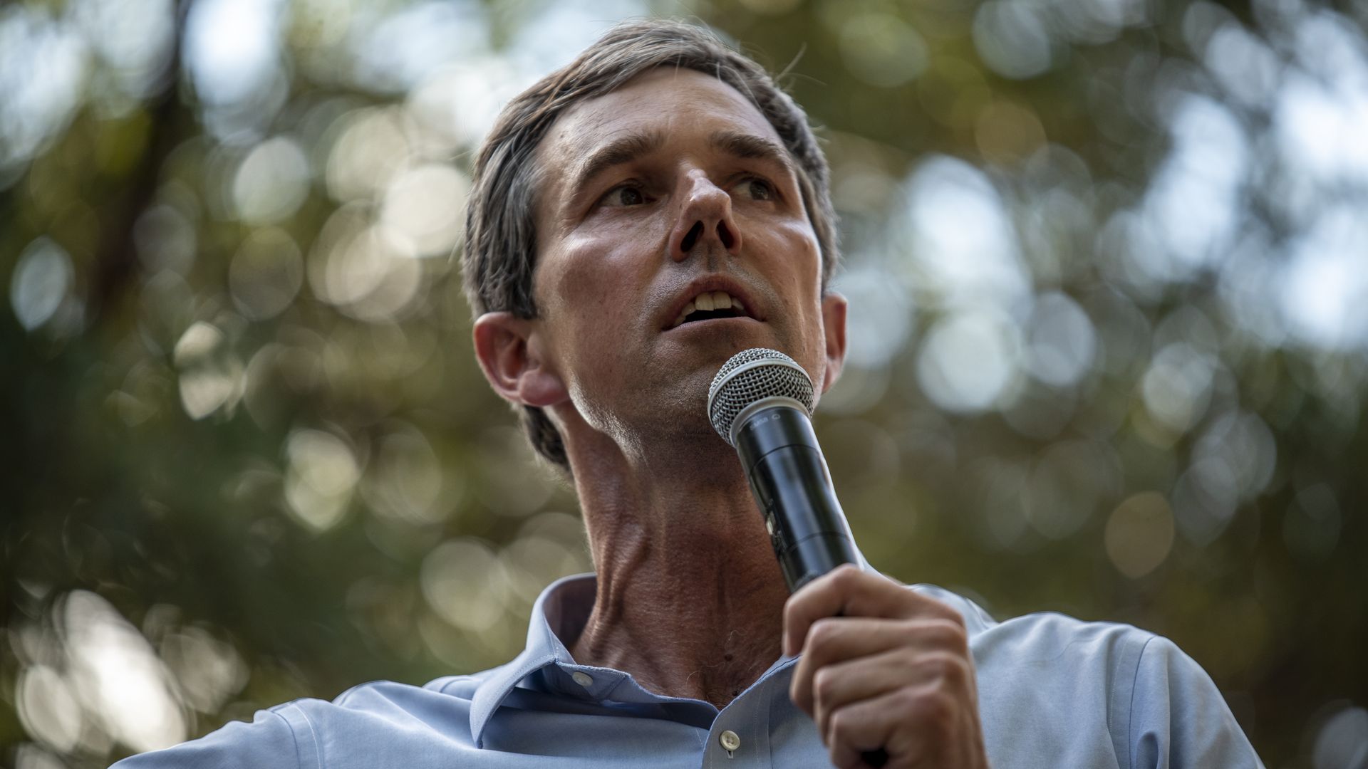 Beto O'Rourke is seen addressing a crowd.