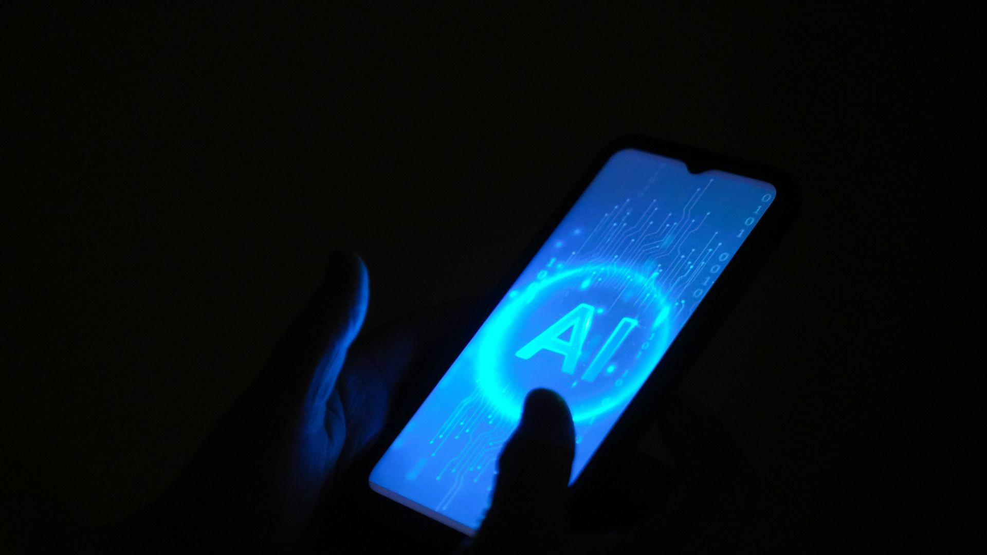 A cell phone with the acronym for artificial intelligence.