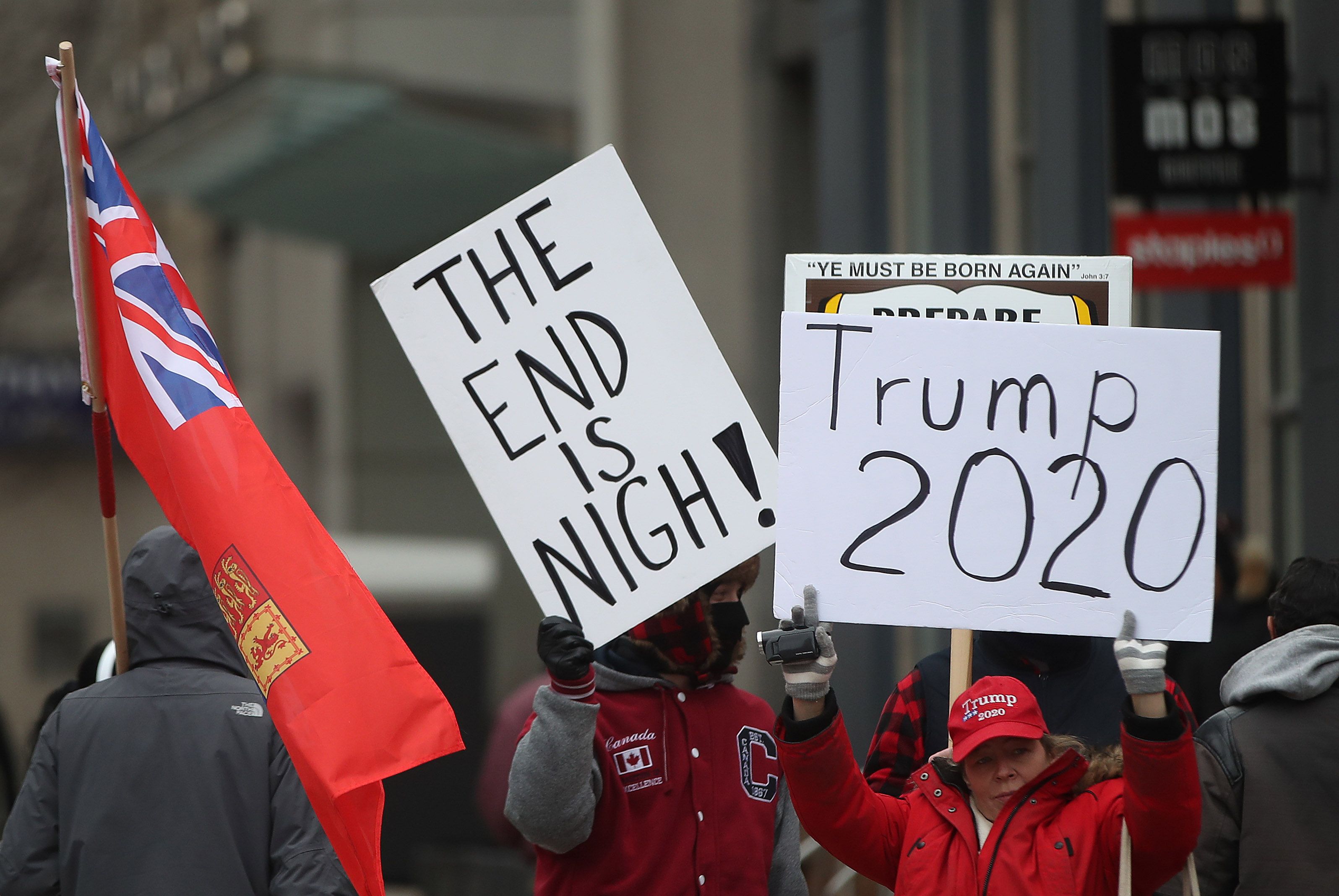  Counter protesters hold signs as peace advocates hold a rally in front of the American Consulate in Toronto. January 4, 2020. (Steve Russell/Toronto Star via Getty Images)