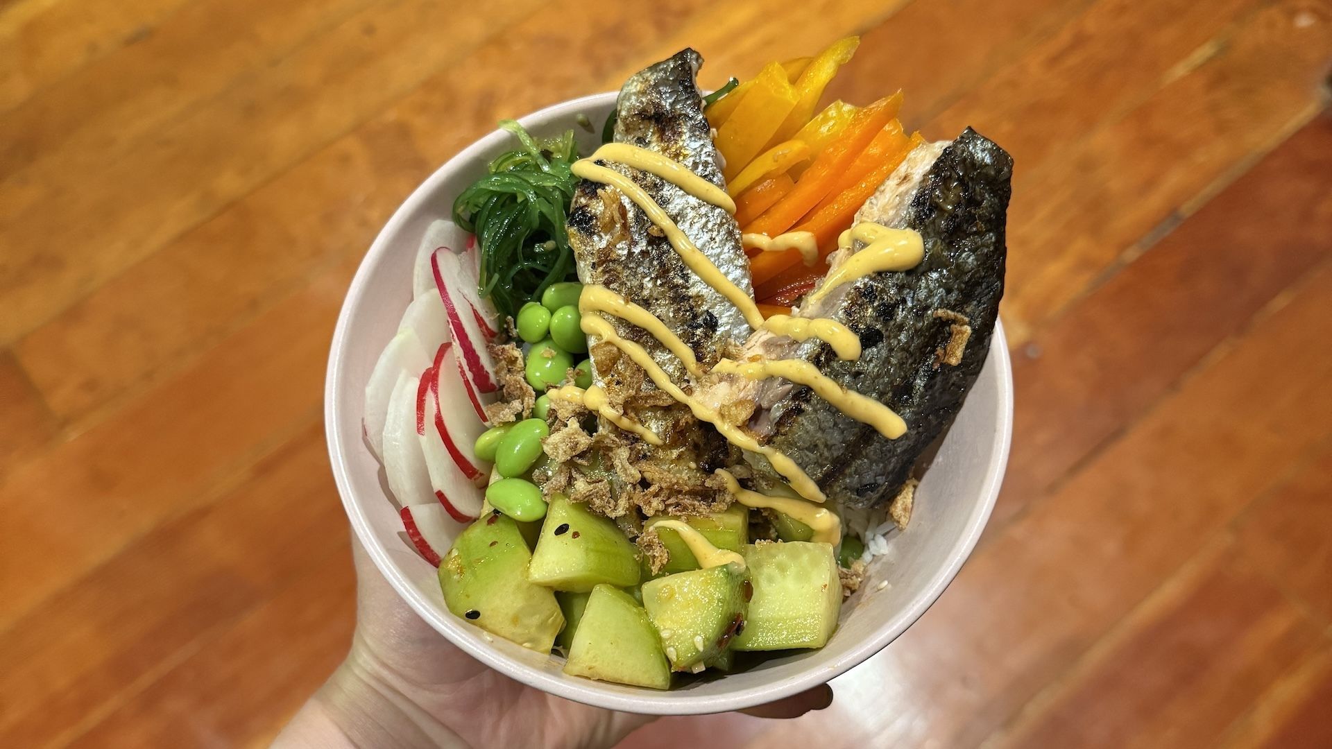 My go-to salmon bowl is a recipe I can adjust based on what's fresh at the market and what's in the fridge. Photo: Claire Reilly/Axios