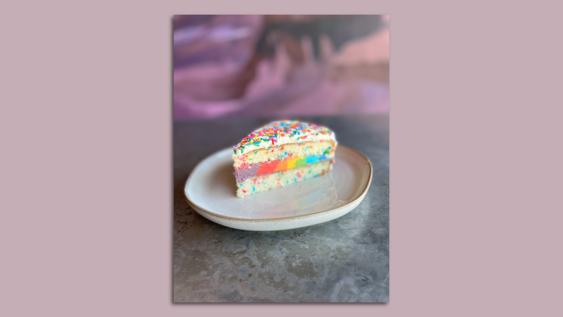 Rainbow confetti cake on a plate.