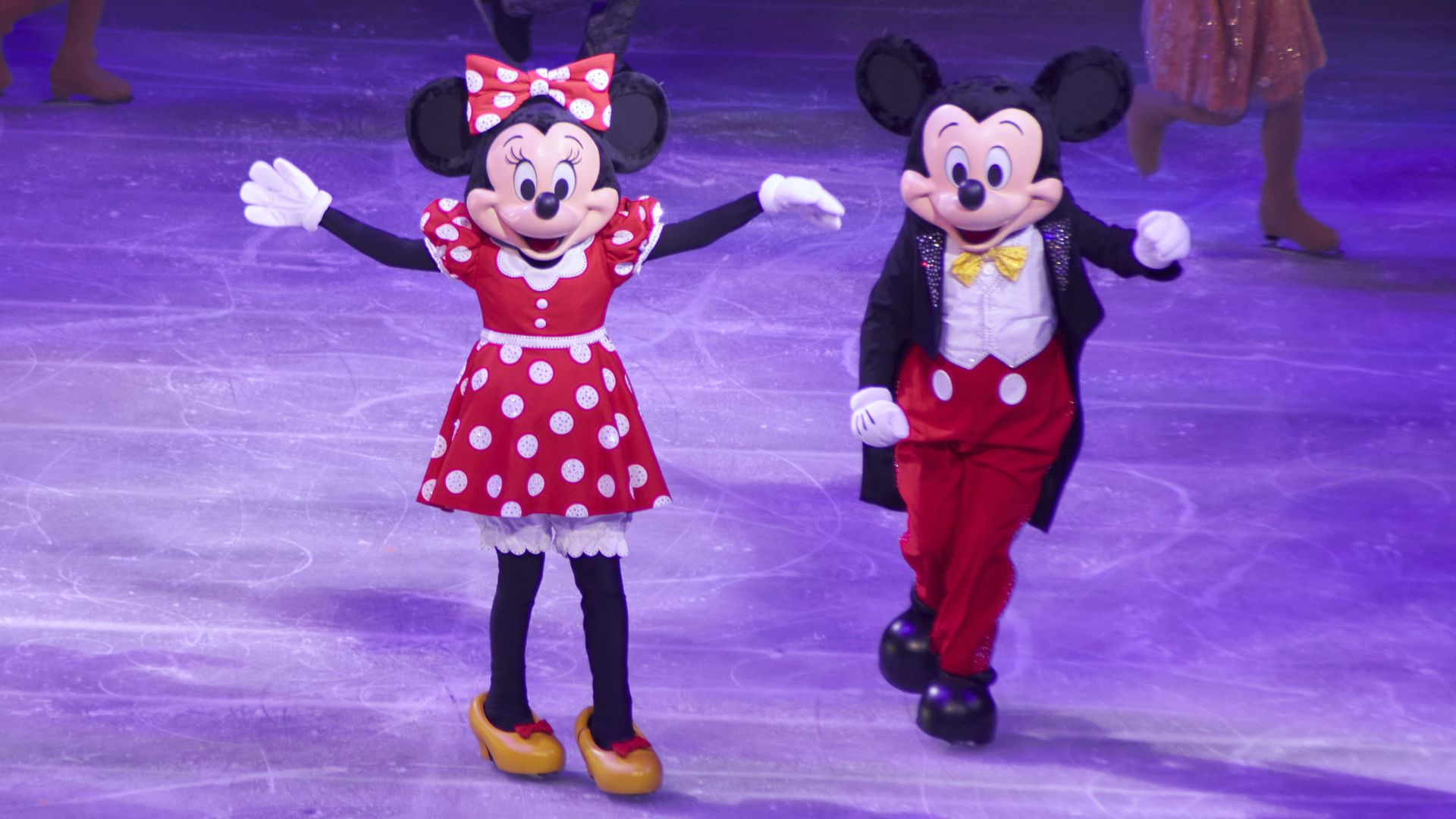 Minnie and Mickey Mouse characters skate during a Disney on Ice show. 