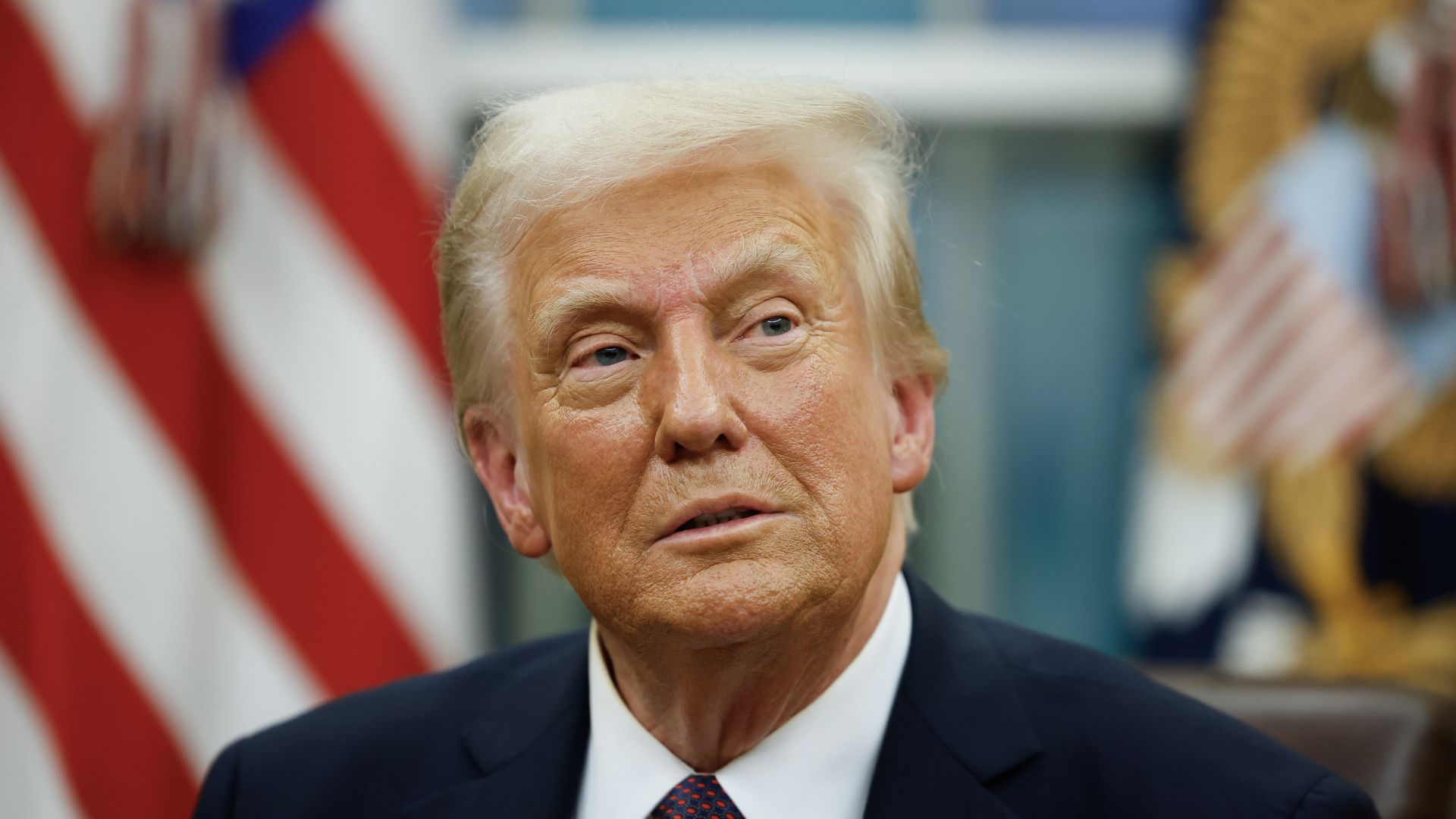 Donald Trump signs executive orders in the Oval Office on January 20