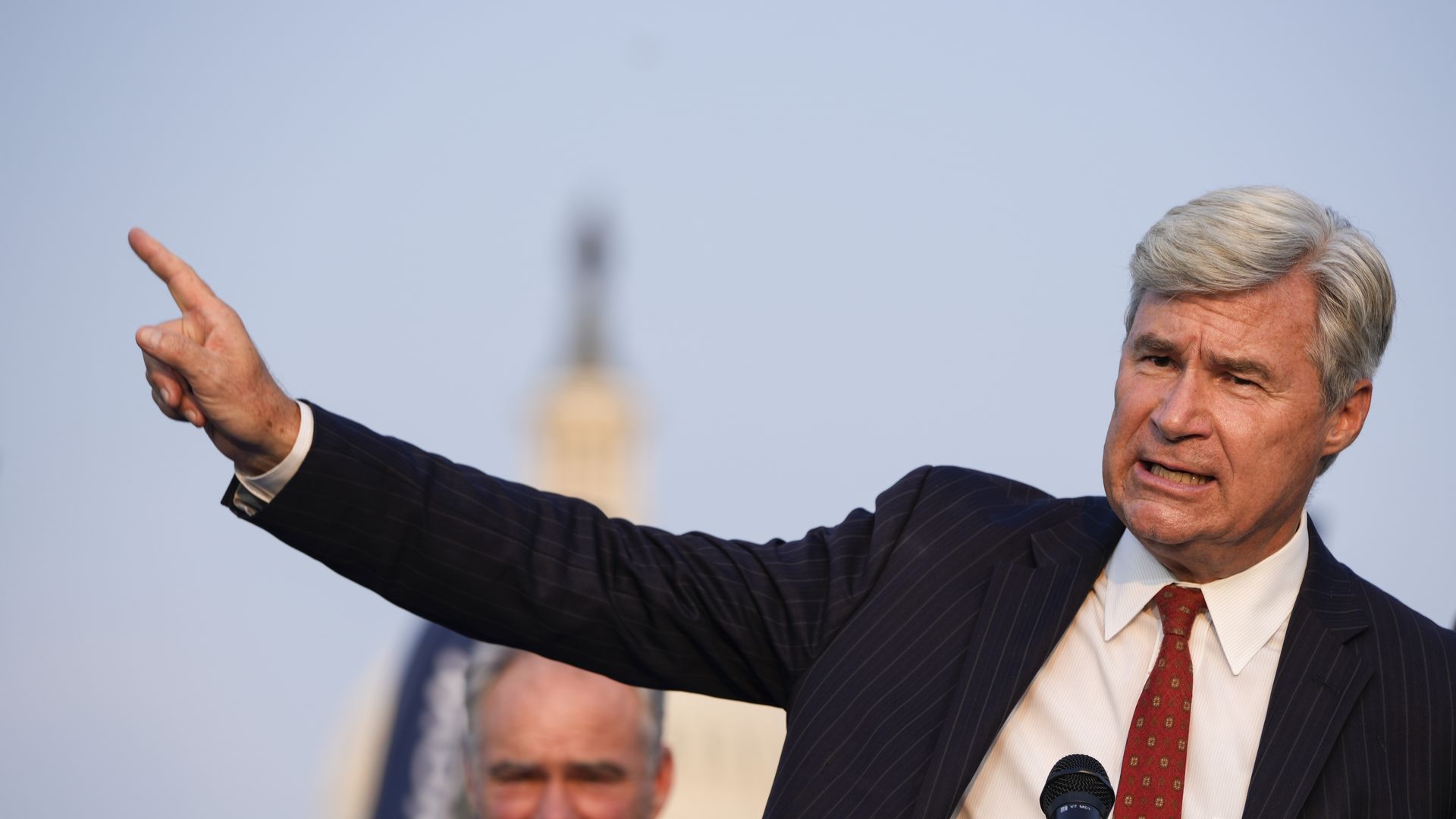U.S. Sen. Sheldon Whitehouse (D-RI) with his arm extended speaks during a rally near the U.S. Capitol.