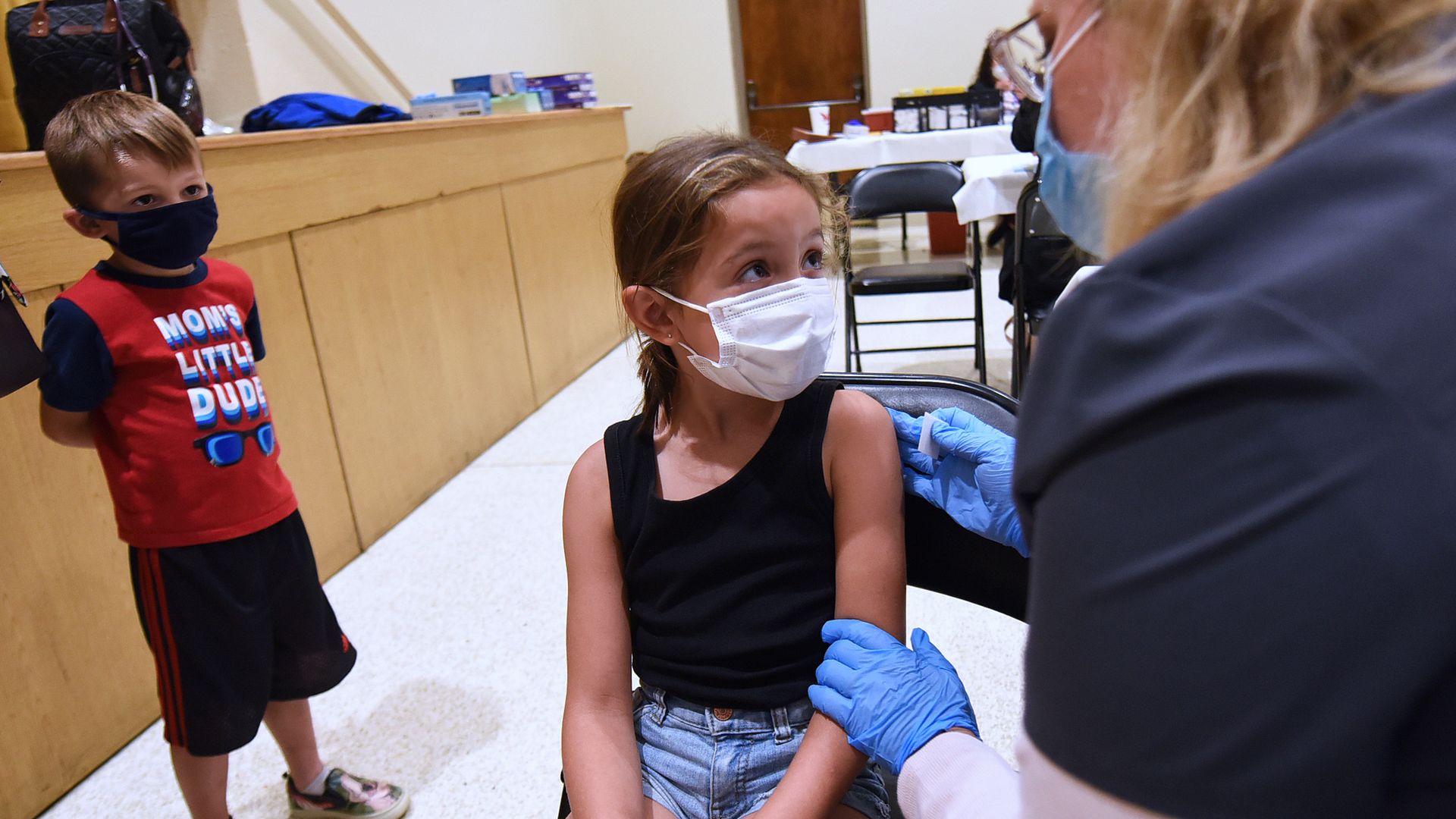 A nurse gives a little girl a shot of the Pfizer COVID-19 vaccine at a vaccination site for 5-11 year-olds at Eastmonte Park.
