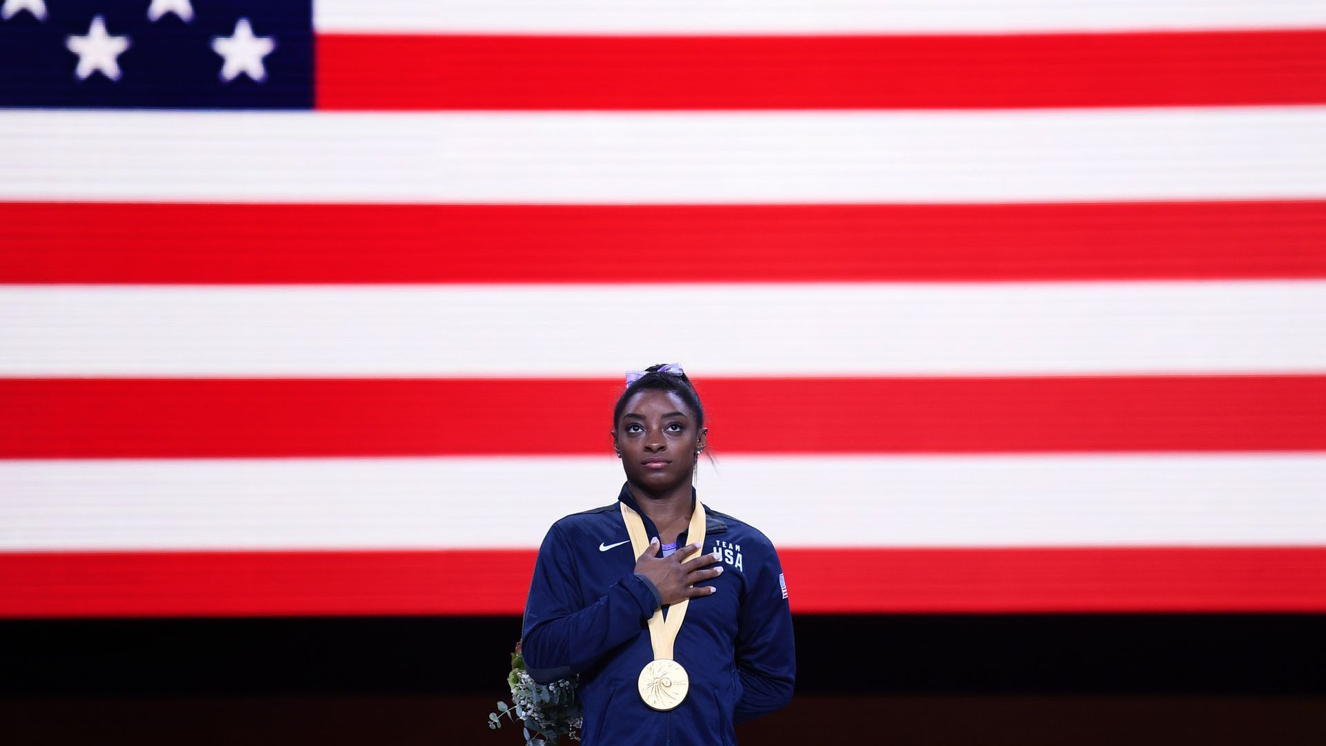 Simone Biles in front of an American flag