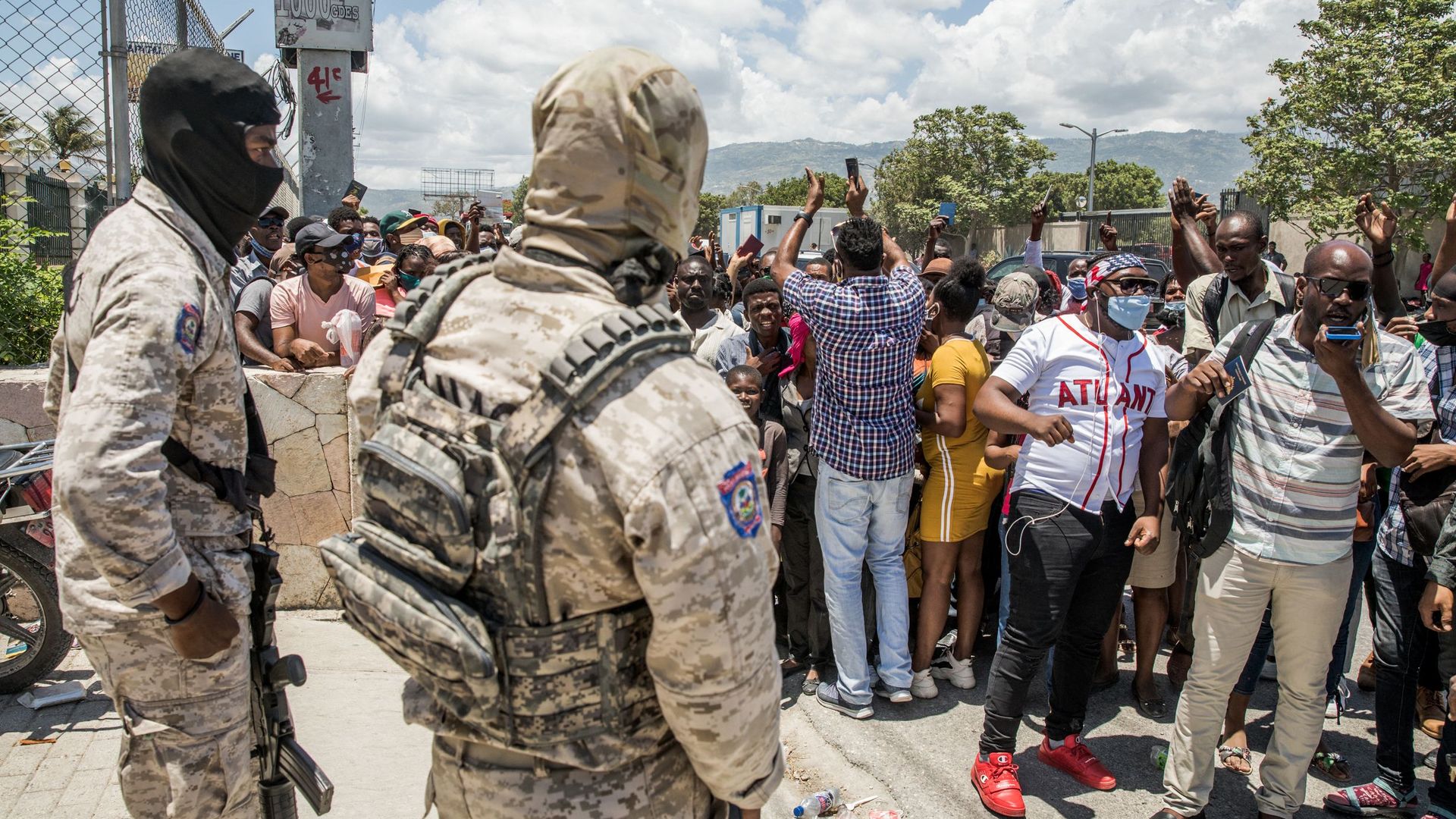 Police look on as Haitian citizens gather in front of the US Embassy in Tabarre, Haiti on July 10