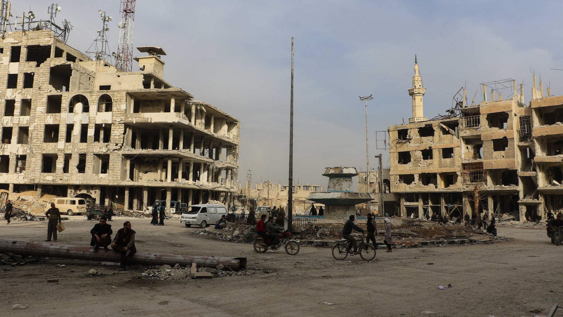 Syrian civilians wait near destroyed buildings to evacuate Arbin town of Eastern Ghouta.