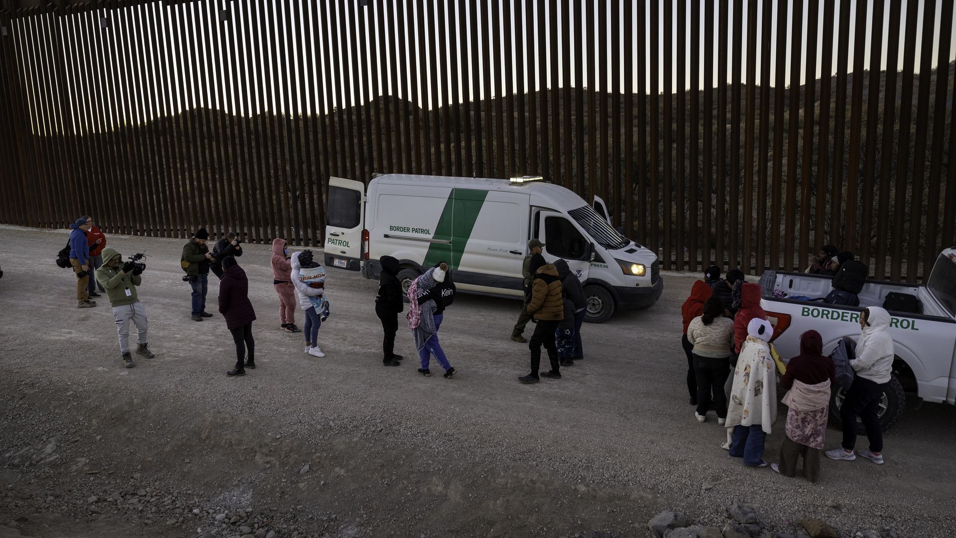Immigrants prepare to be transported by U.S. Border Patrol agents after crossing the U.S.-Mexico border on January 20, 2025 near Sasabe, Arizona. Immigrant families had passed through a gap in the Trump-built border wall hours before Donald J. Trump was inaugurated for a second time as President of 