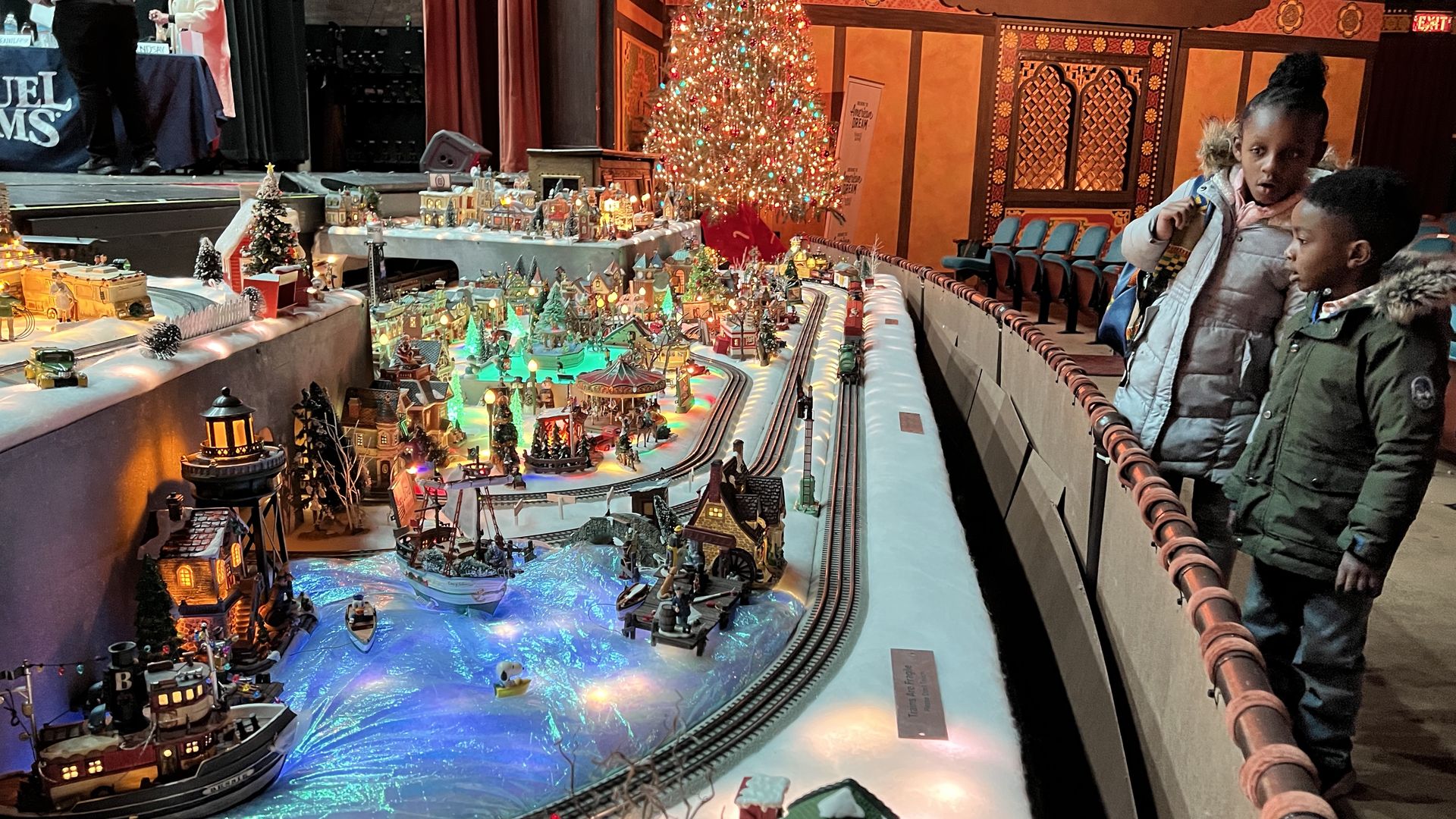 Kids gaze in awe at the Christmas train display inside the Redford Theatre