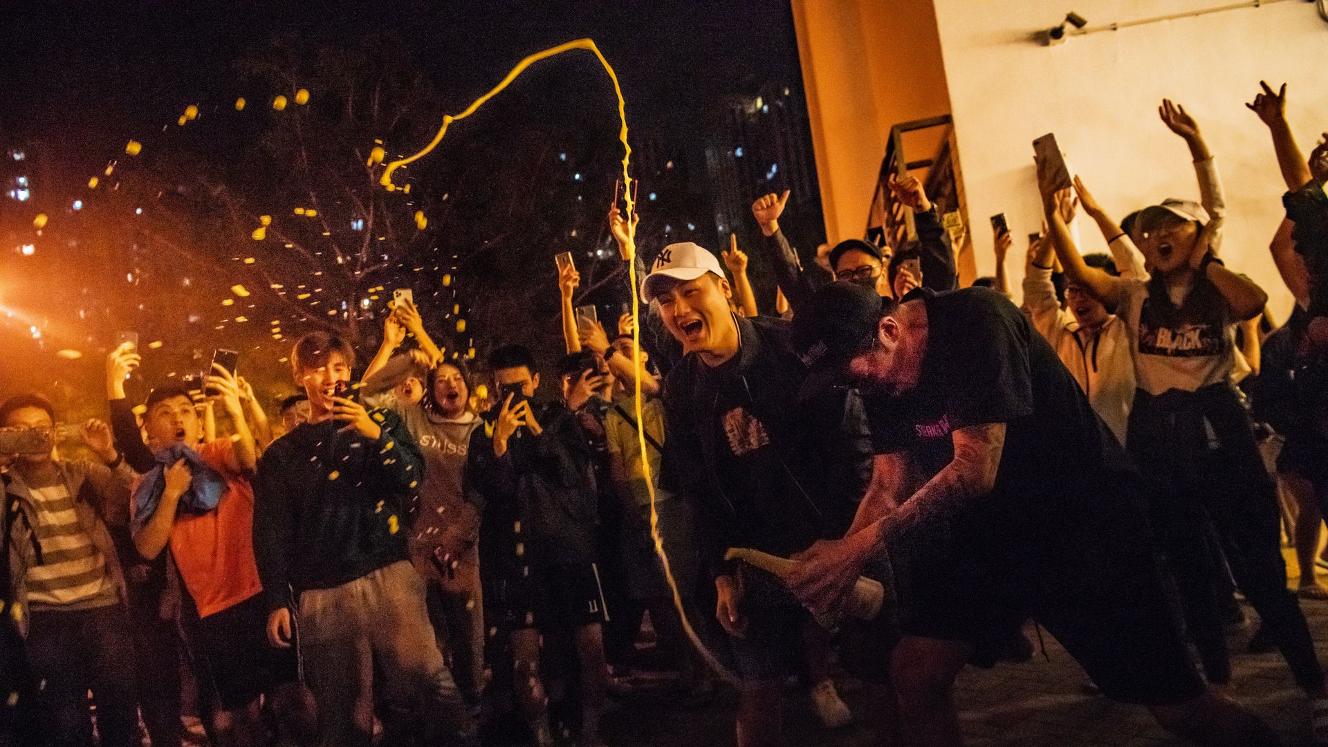 Local residents celebrate outside a polling station as Junius Ho Kwan-yiu loses in District Council Elections on November 25, 2019 in Hong Kong