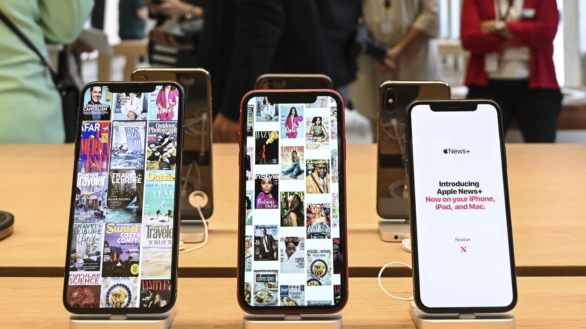 Photo of six iPhones displayed standing up at an Apple store