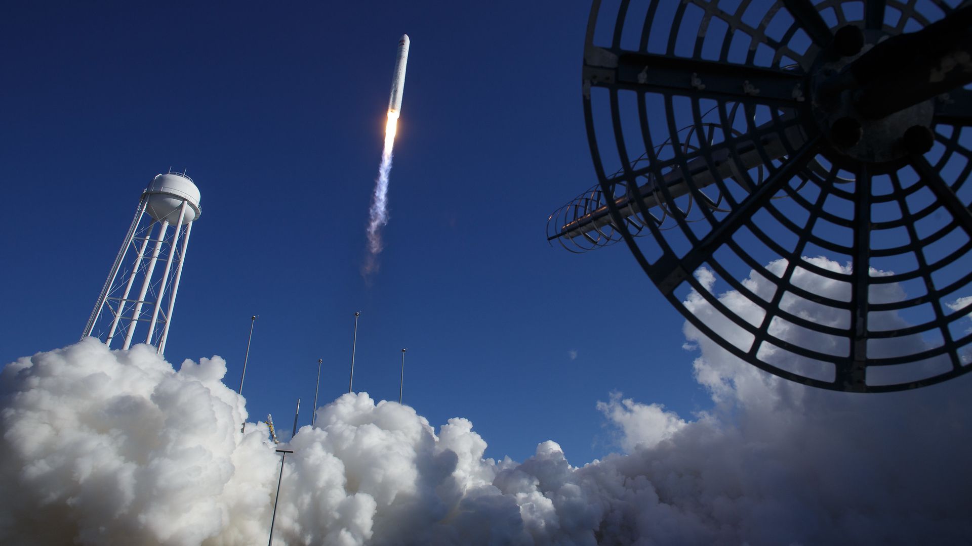 A rocket launching from Virginia into a clear blue sky