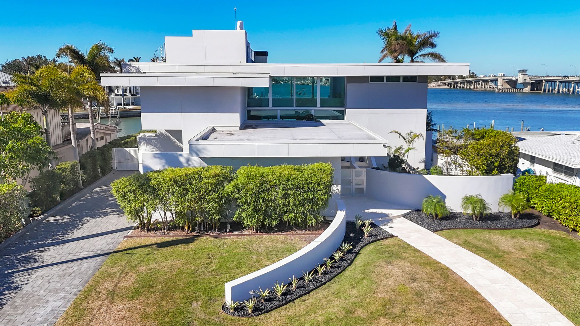 A white modern house on the water.