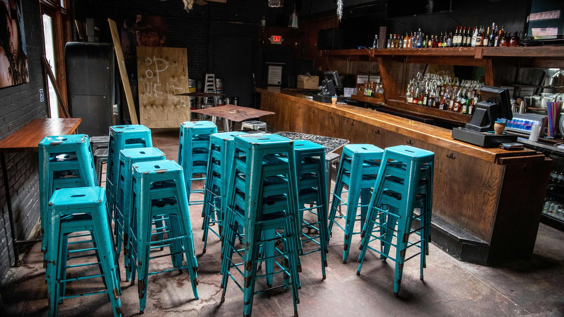 An empty bar in Texs with bar stools stacked on top of each other